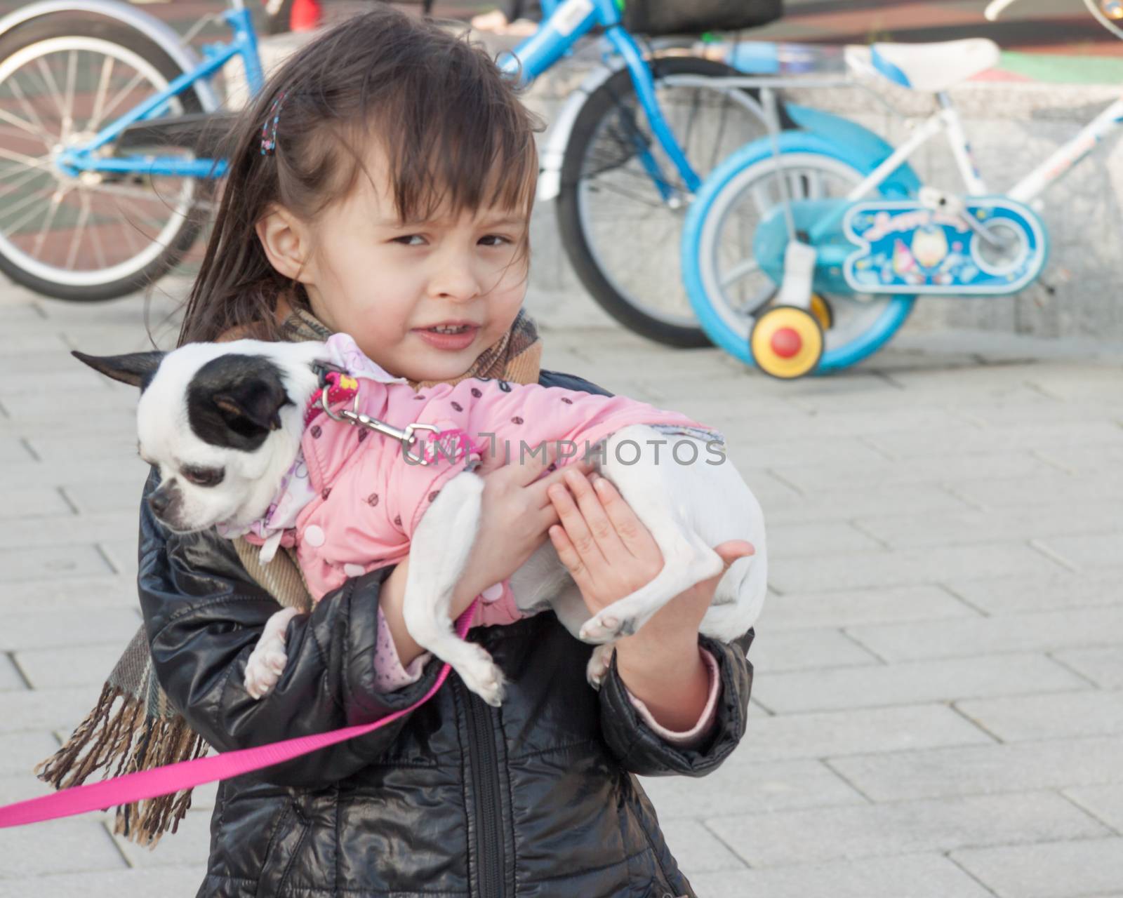 Young girl carrying dog by imagesbykenny