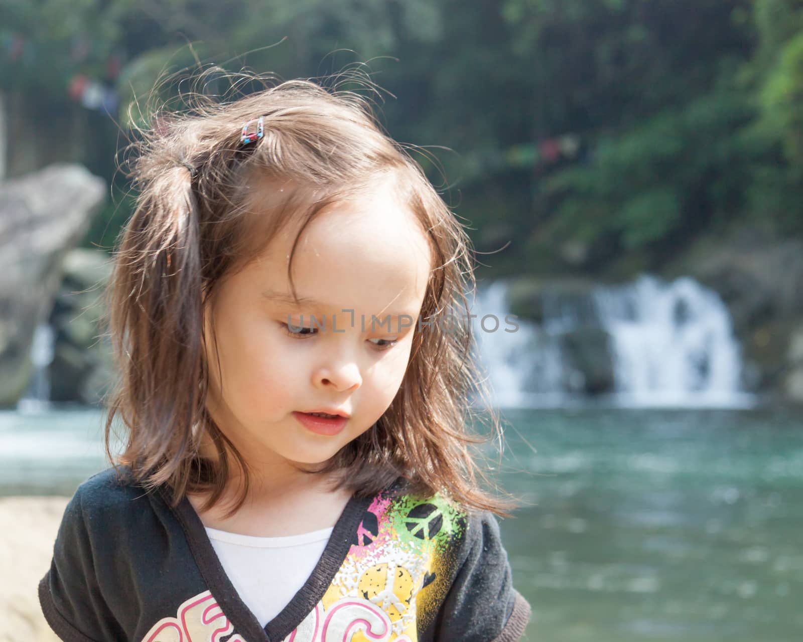 Young girl in front of waterfall by imagesbykenny