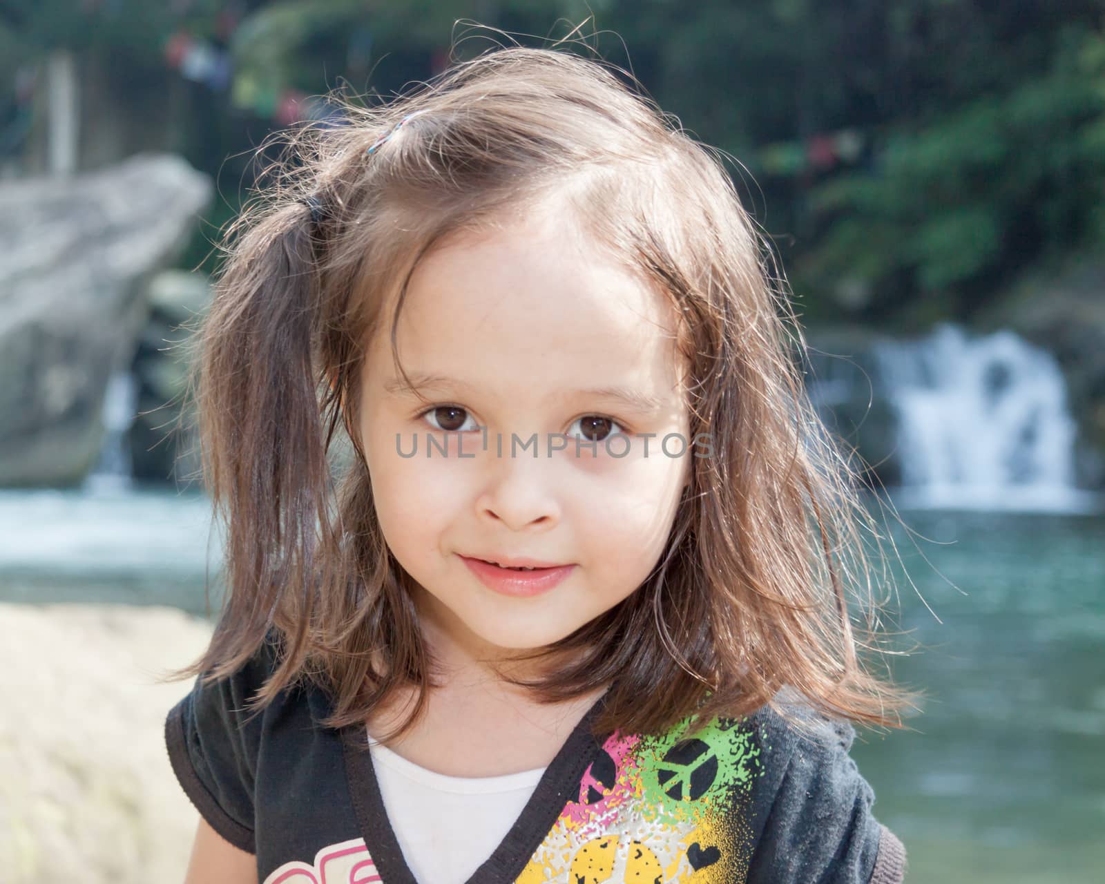 Young girl in front of waterfall by imagesbykenny