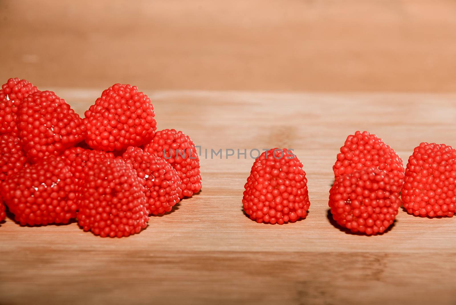 Sweet ripe blackberries on a wooden table and a rear soft background.
