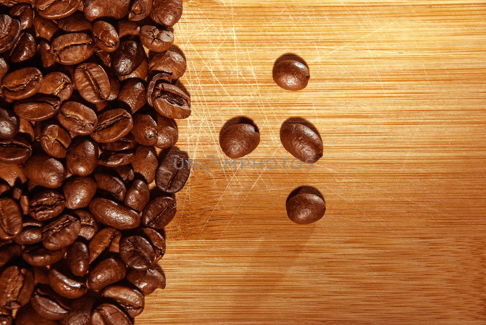 Bunch of fresh coffee beans on wooden table.