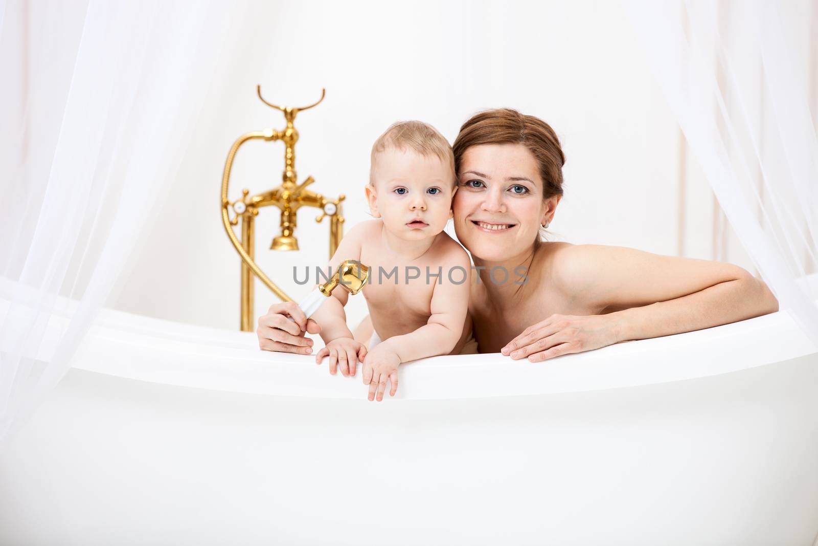 Loving mother and little son in bathtub