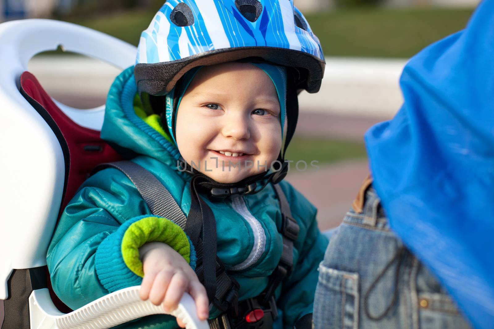 Little boy in the seat bicycle behind father by photobac