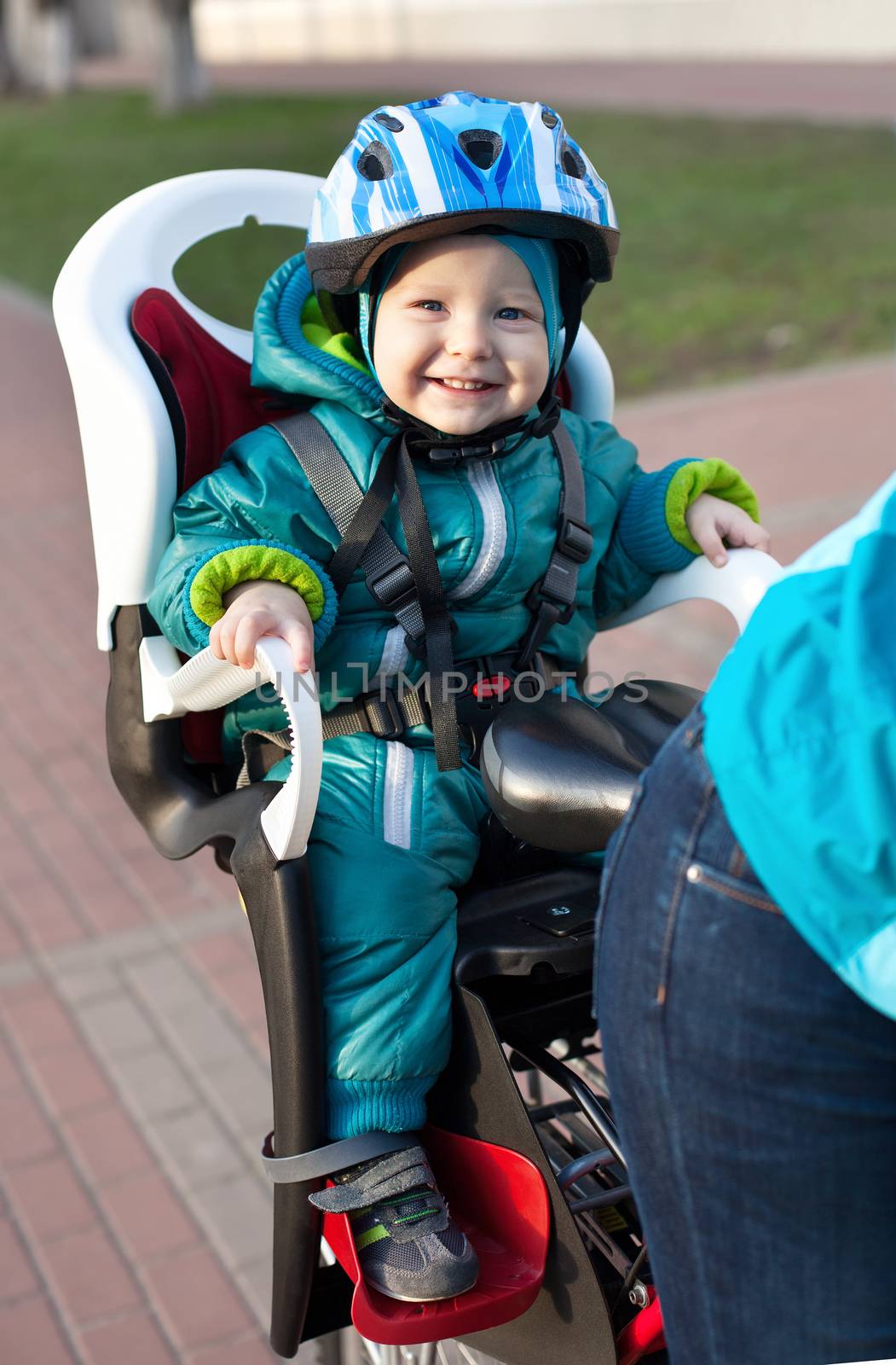 Little boy in the seat bicycle behind mother by photobac