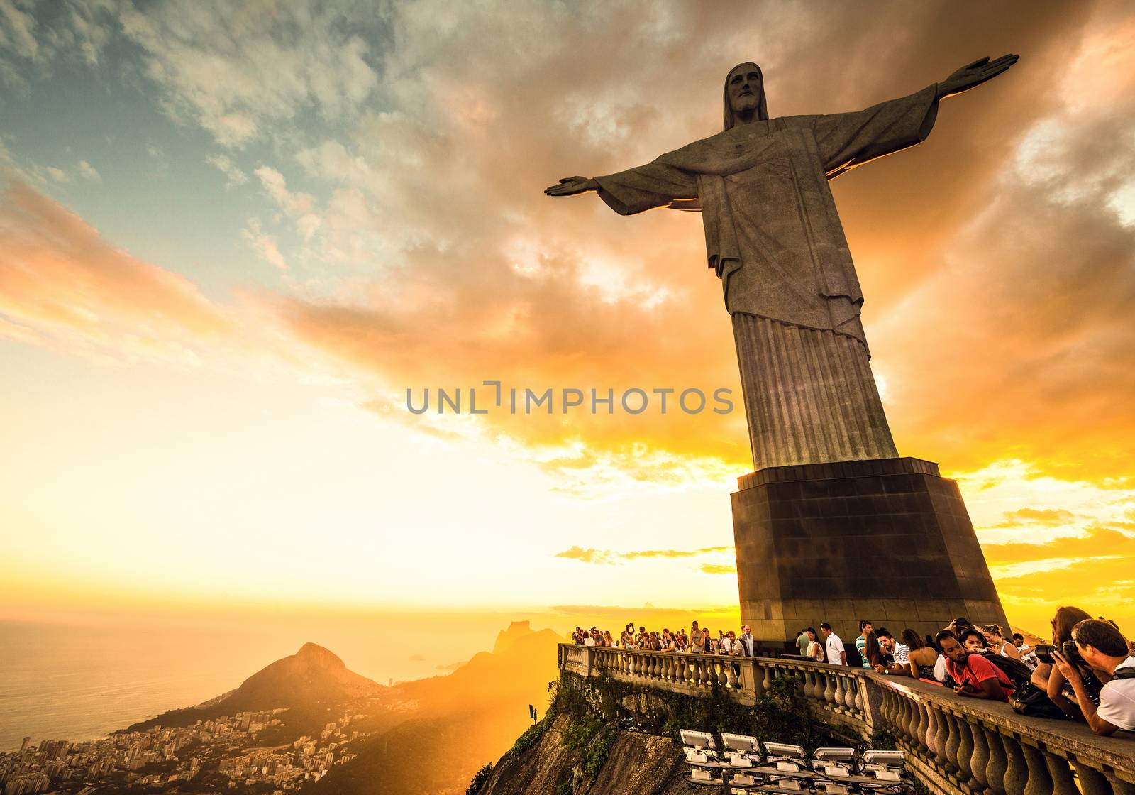 RIO DE JANEIRO, MARCH 3: Tourists are happy to see the first sunset after a week of rain and thunderstorms on the Corcovado Hill - march 3, 2013 in Rio de Janeiro, Brazil. In 2007 was elected one of the new seven wonders of the world.