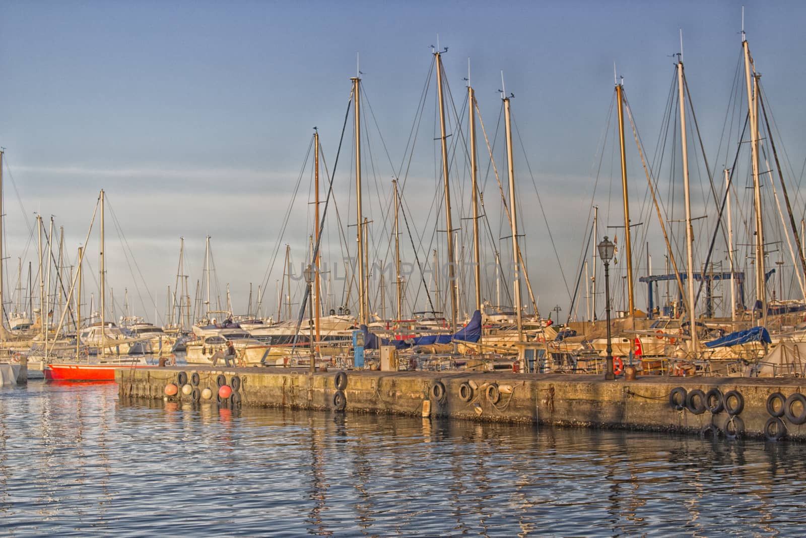 Sailing and engine boats moored in the harbour channel of Cervia in Northern Italy on the Adriatic Sea