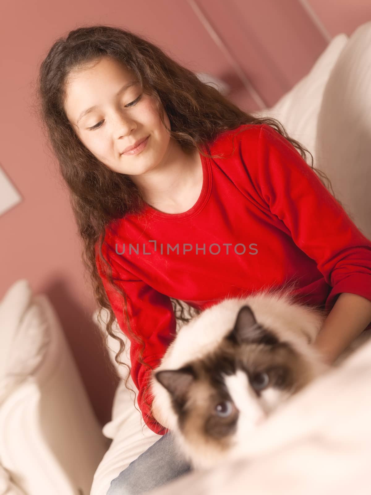 An image of a young girl with her cat