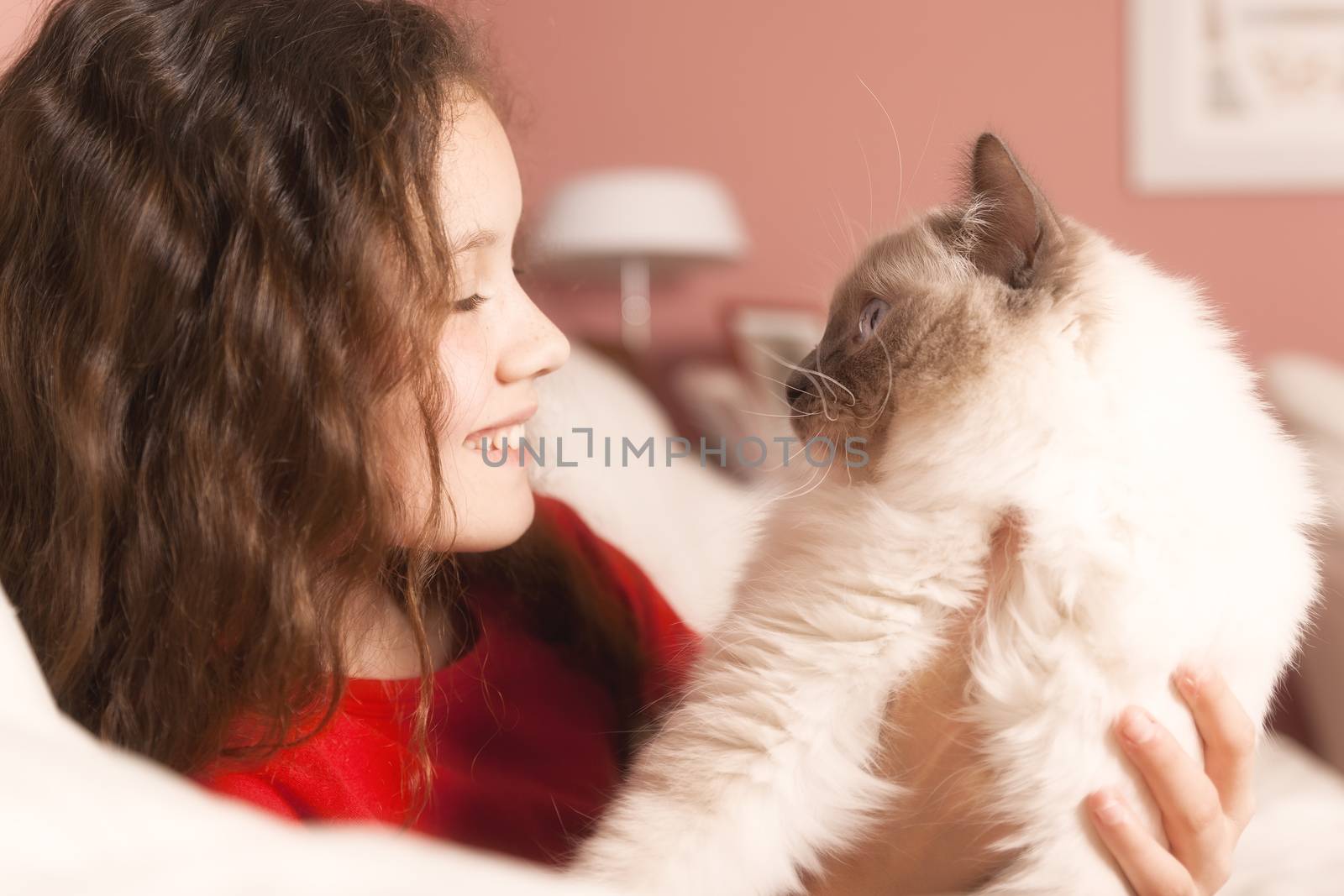 An image of a young girl with her cat