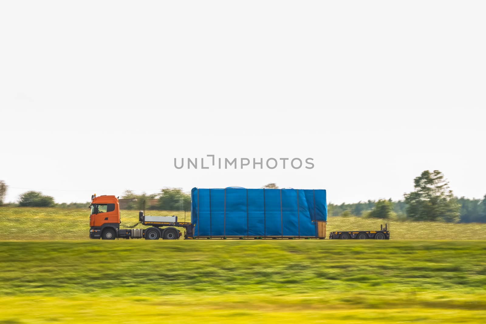 Truck delivery oversized cargo on the country road