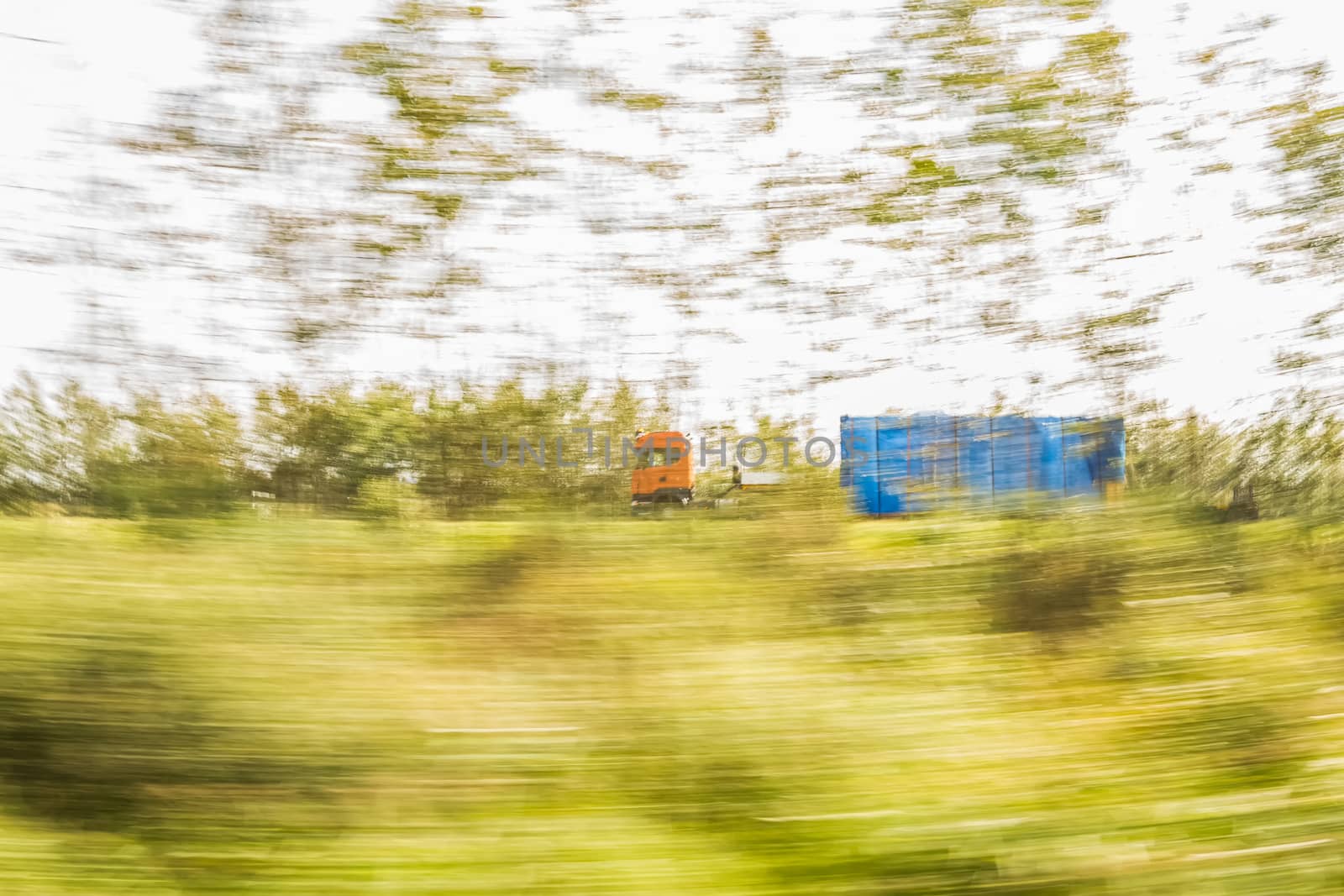 Truck delivery oversized cargo behind the trees