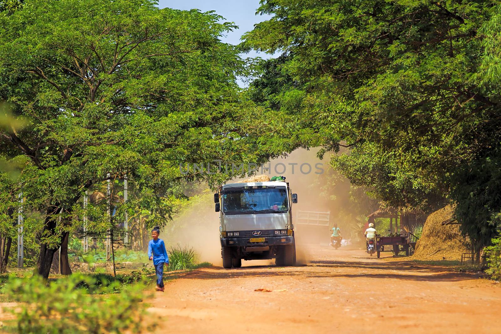 Truck on dusty road in Treak village, Siem Reap