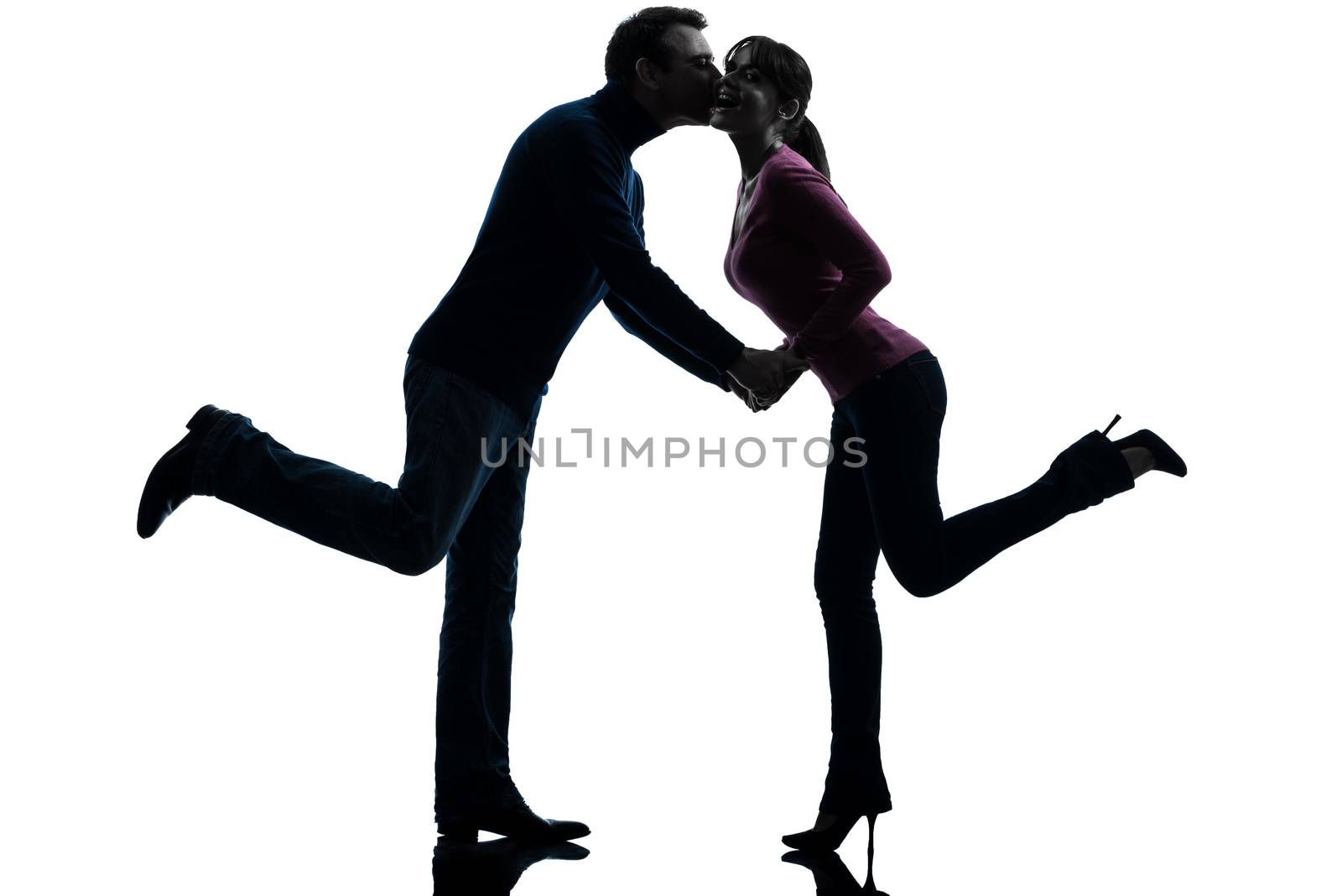 one caucasian couple woman man lovers kissing  in silhouette studio isolated on white background