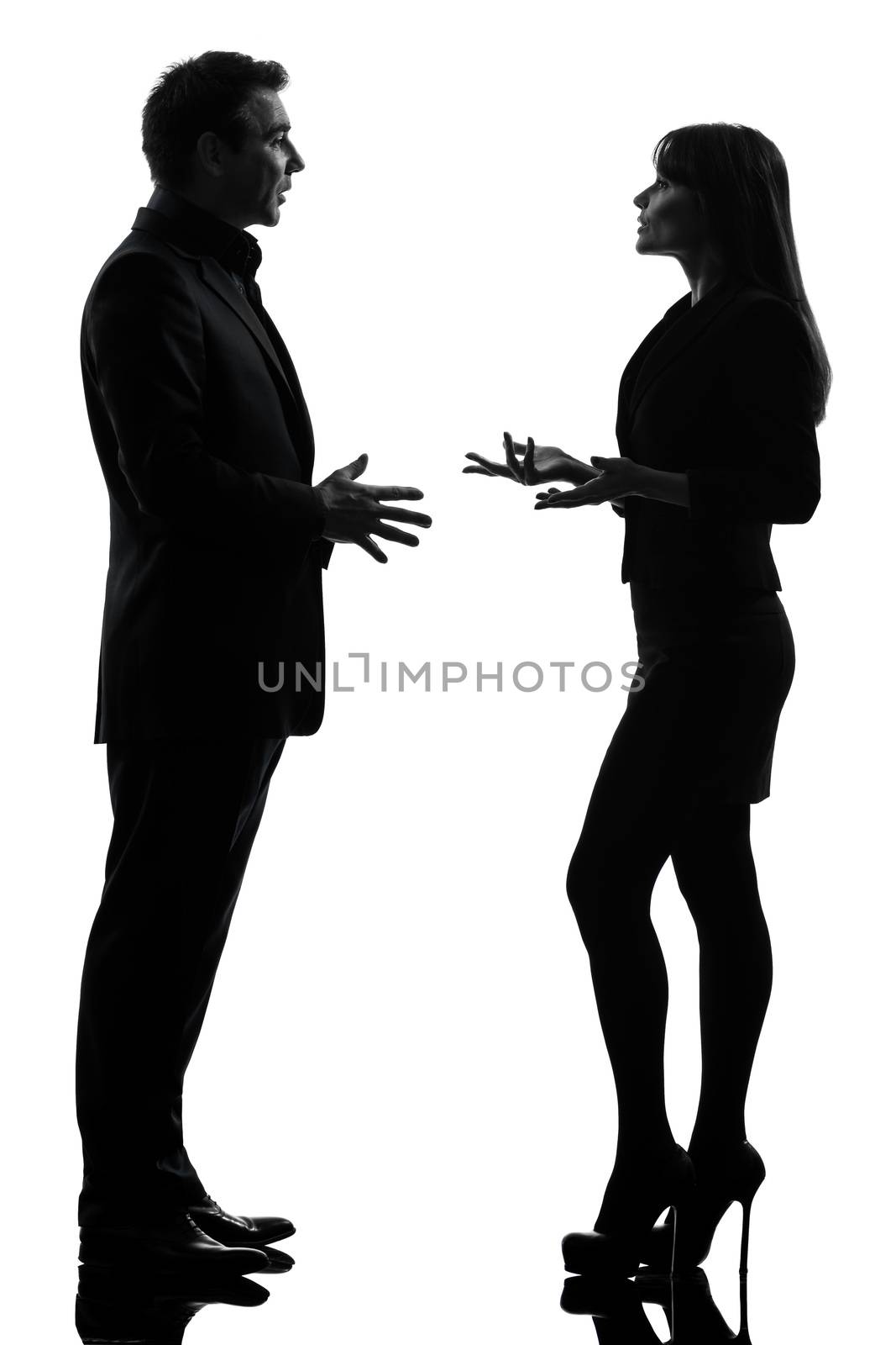 one caucasian business couple woman man in silhouette studio isolated on white background