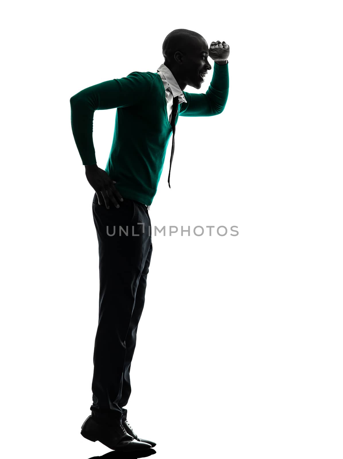 one african black man standing tiptoe looking away  in silhouette studio on white background