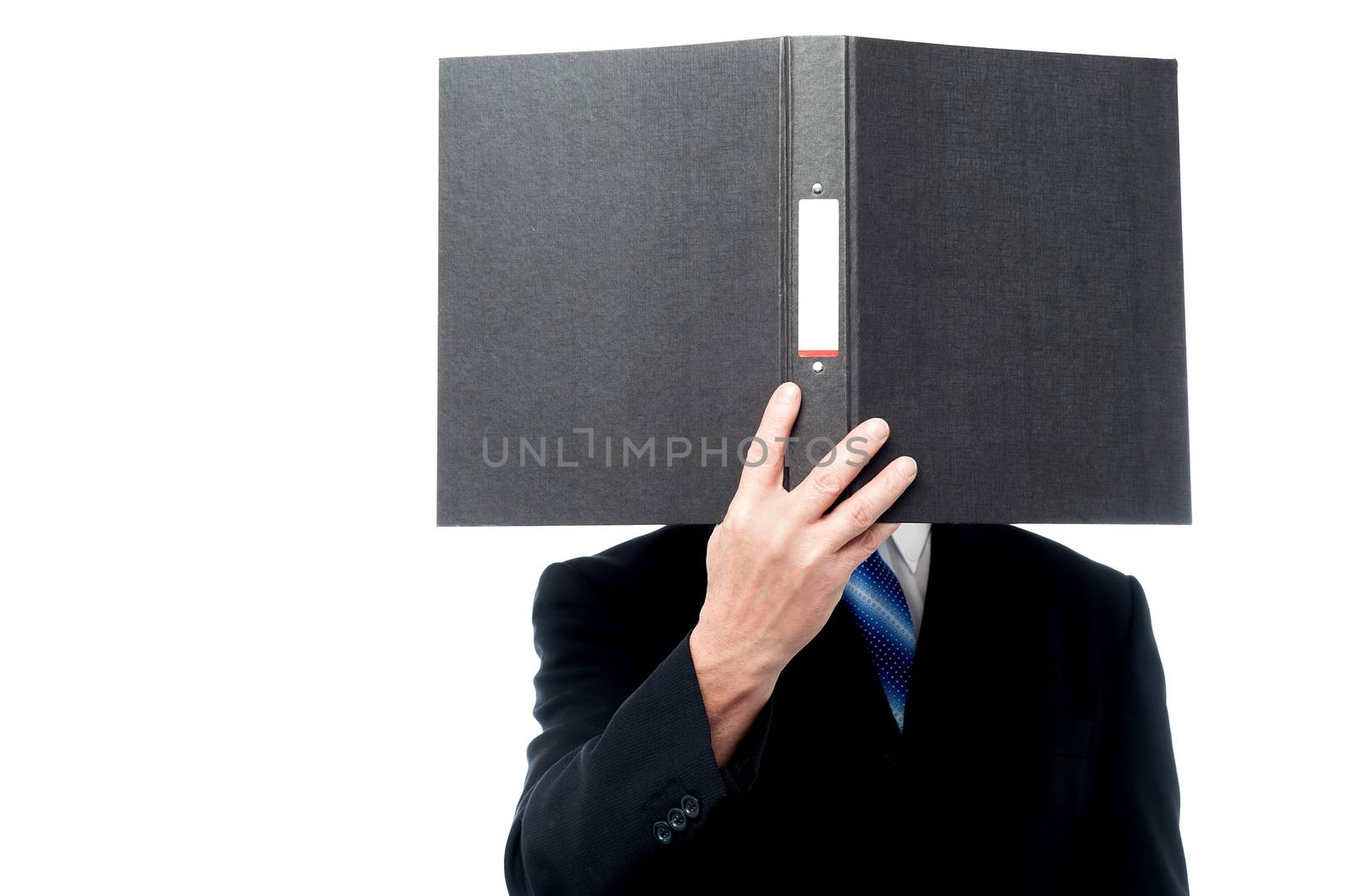 Businessman holding file pad and cover his face by stockyimages