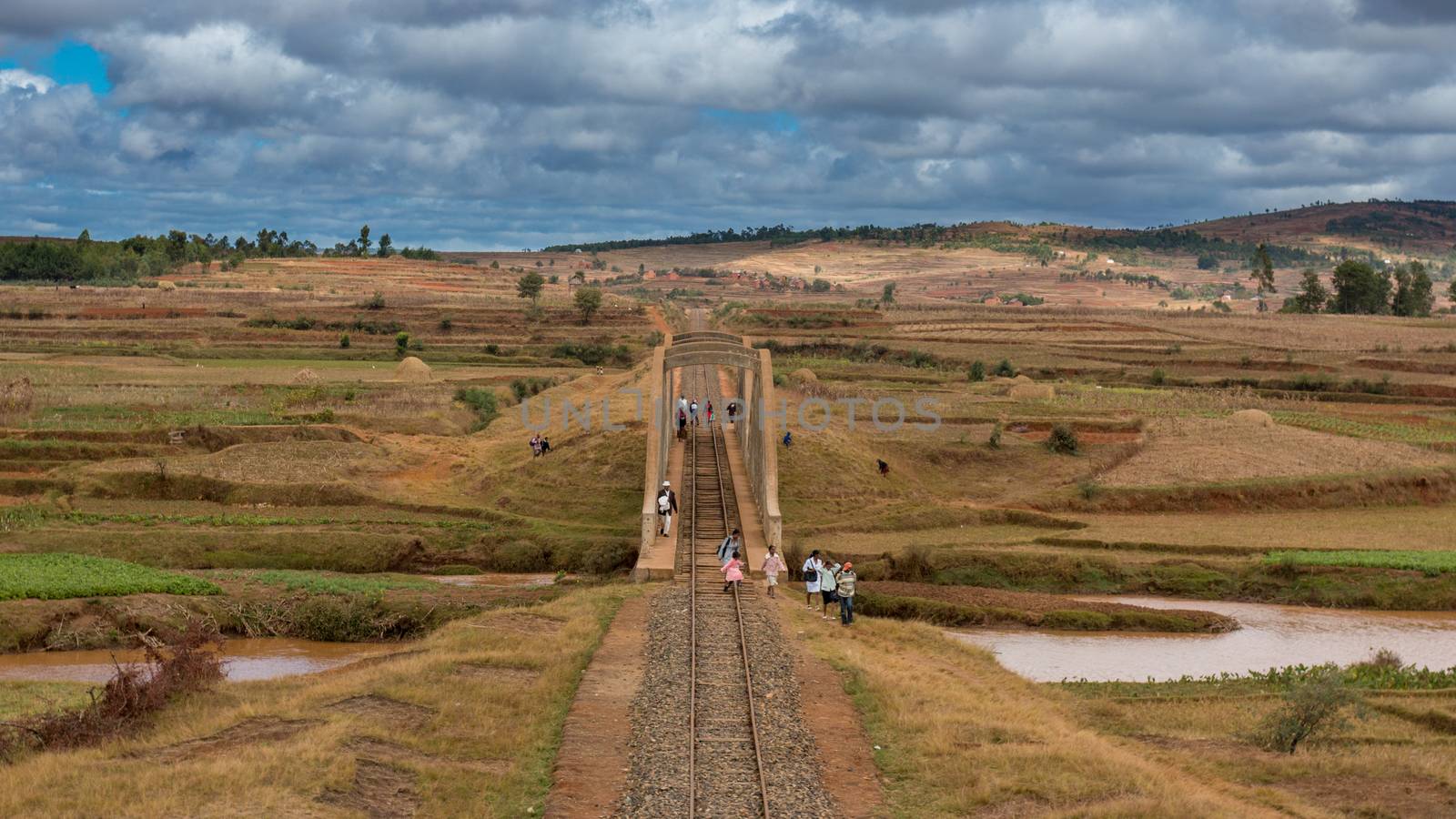 Malagasy people from the countryside cross a railroad bridge on the way to work and school on May 25, 2014 in Madagascar.