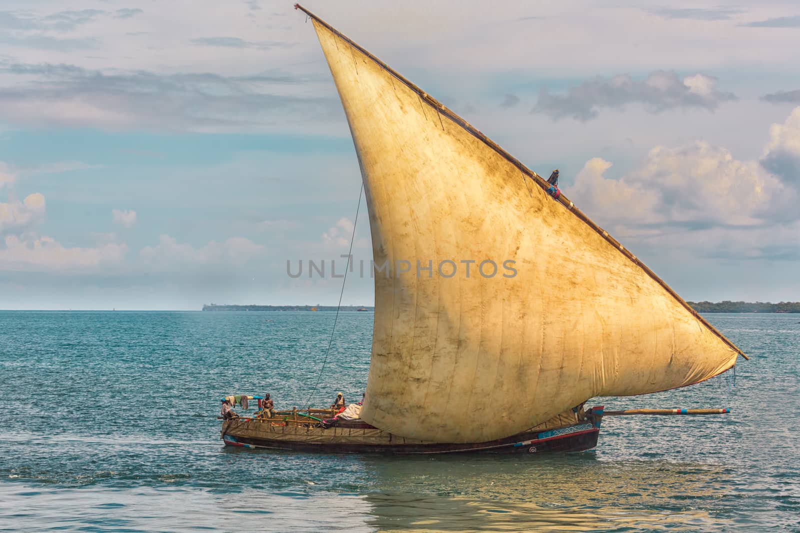 An old wooden boat with local fishermen near the shores of Dar es Salaam, Tanzania