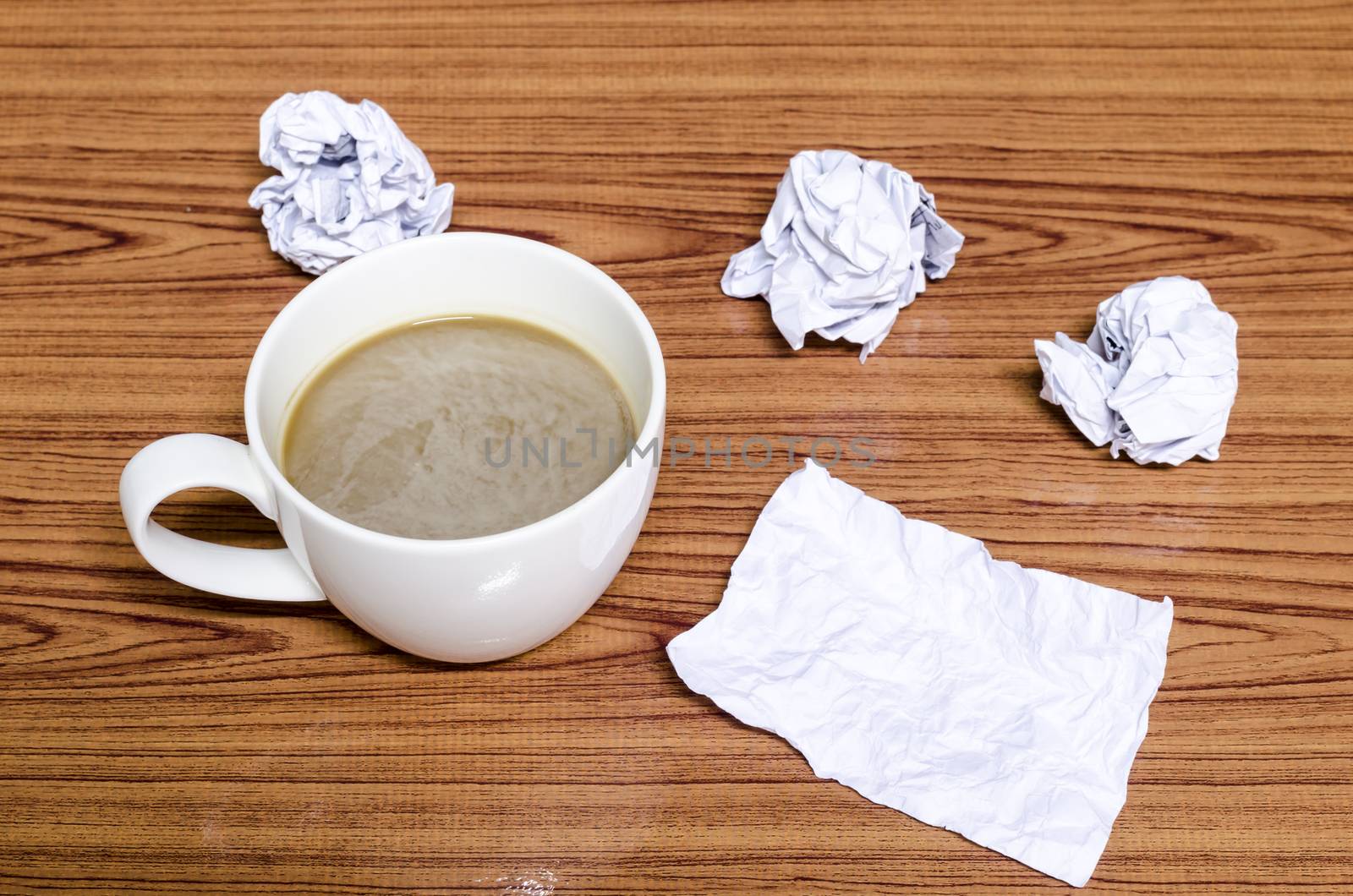 coffe cup and crumpled for idea on wood background