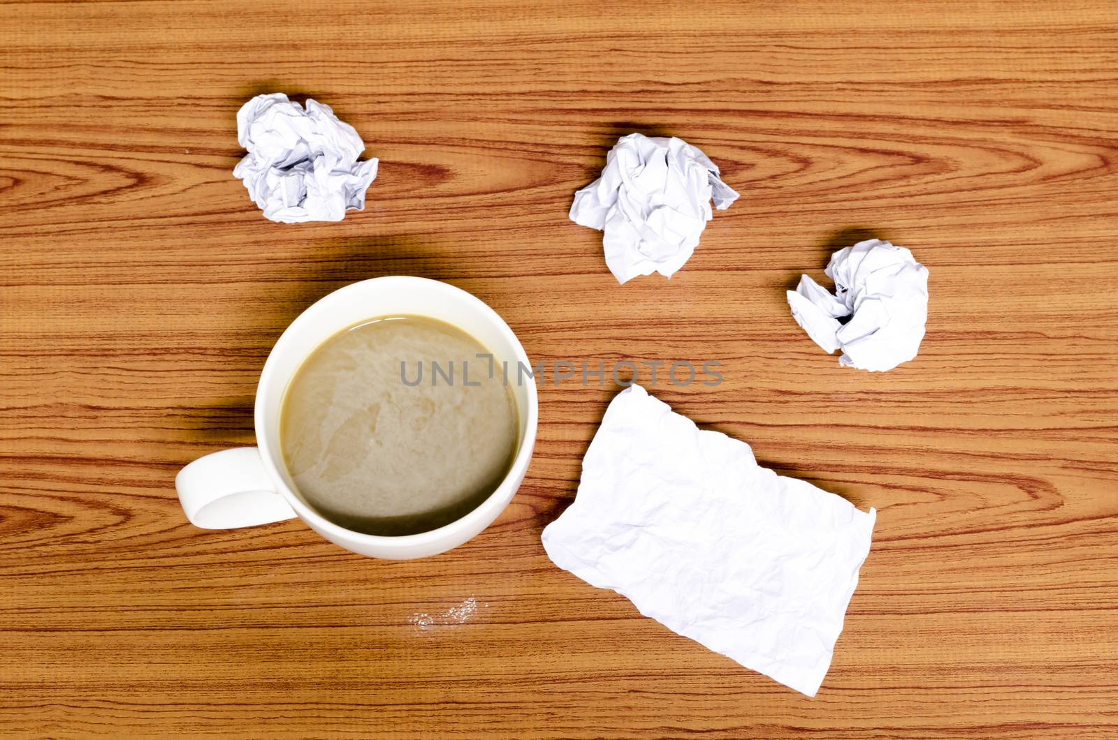 coffe cup and crumpled for idea on wood background