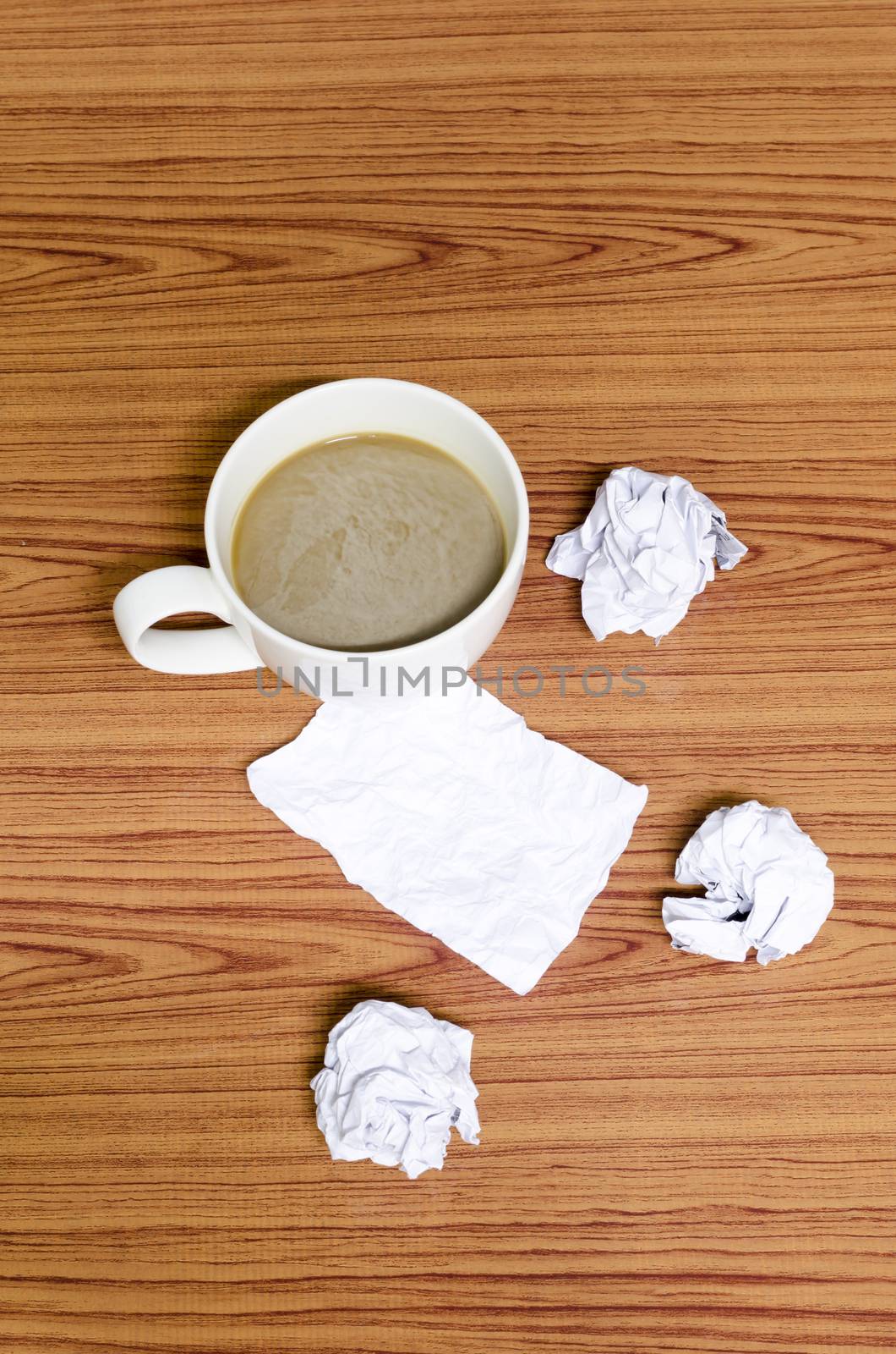 coffe cup and crumpled for idea on wood background