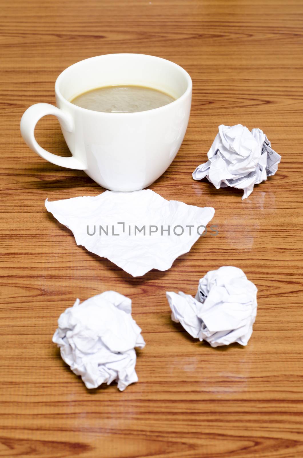 coffe cup and crumpled for idea on wood background