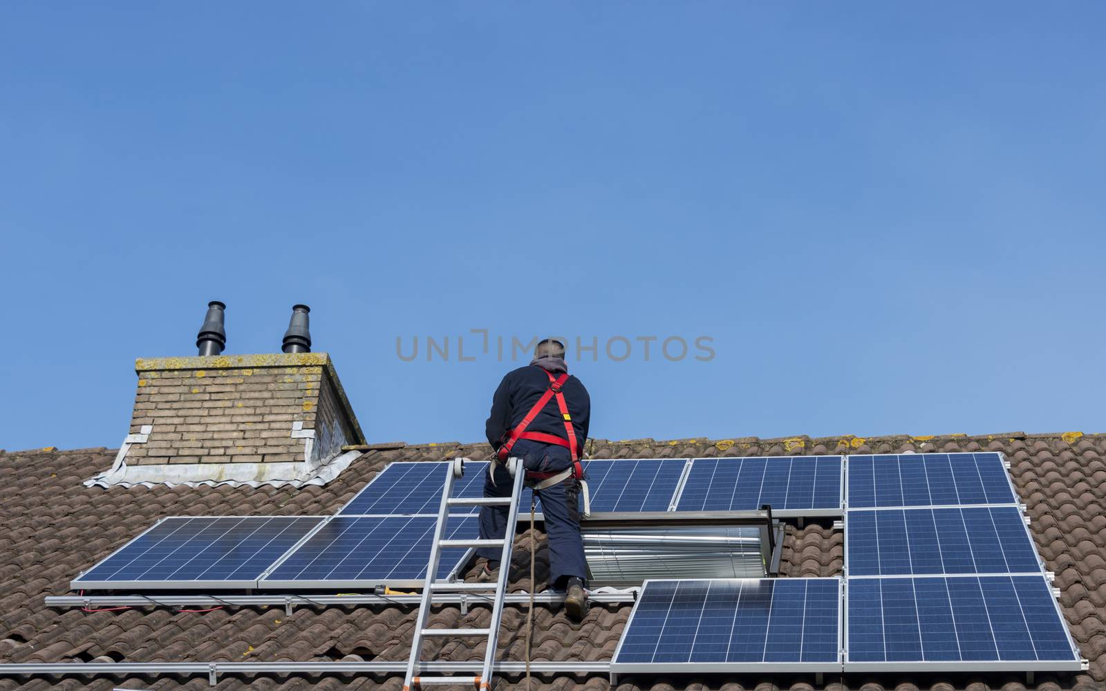 man making construction with solar panels by compuinfoto