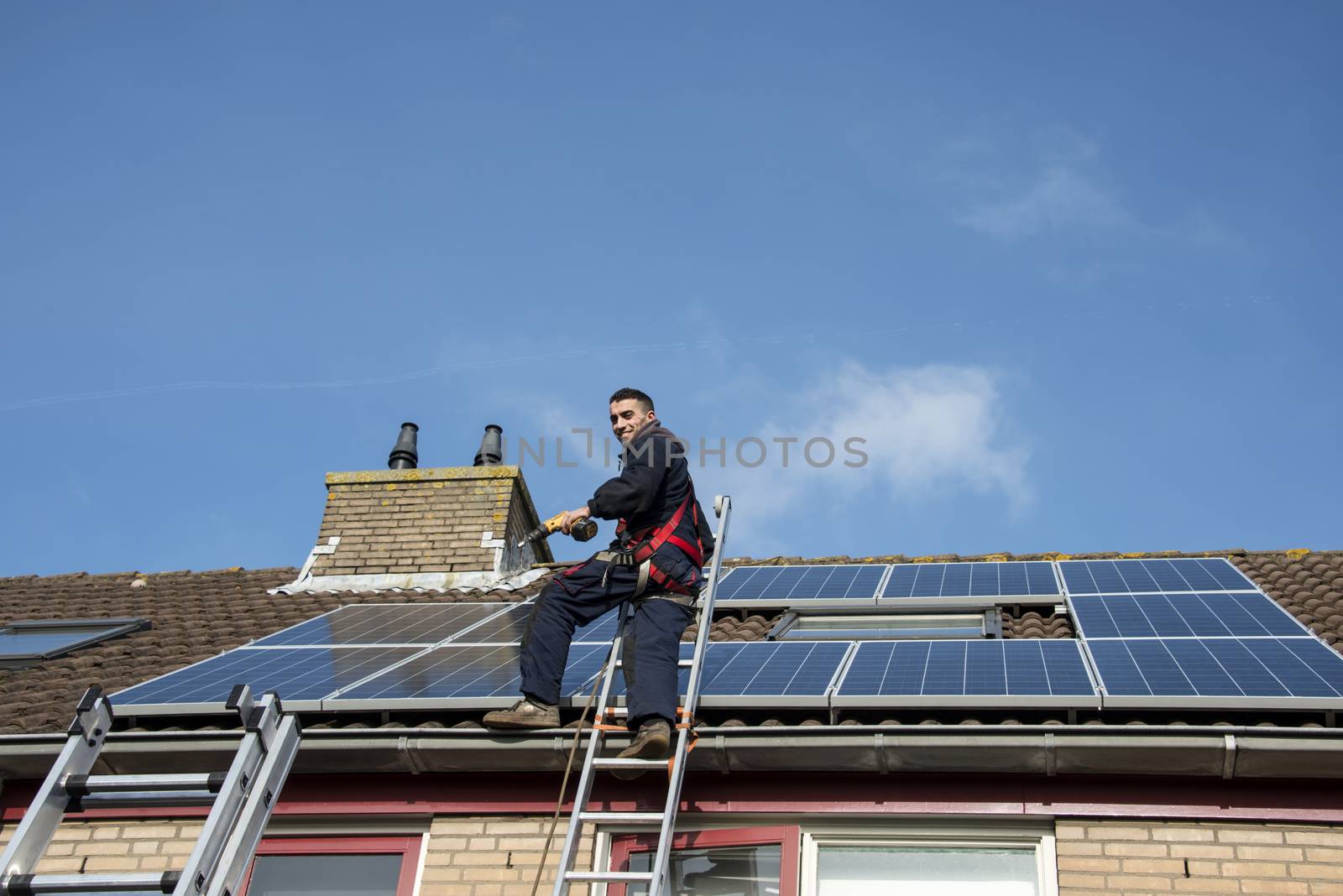 man smiling and happy with solar panels by compuinfoto