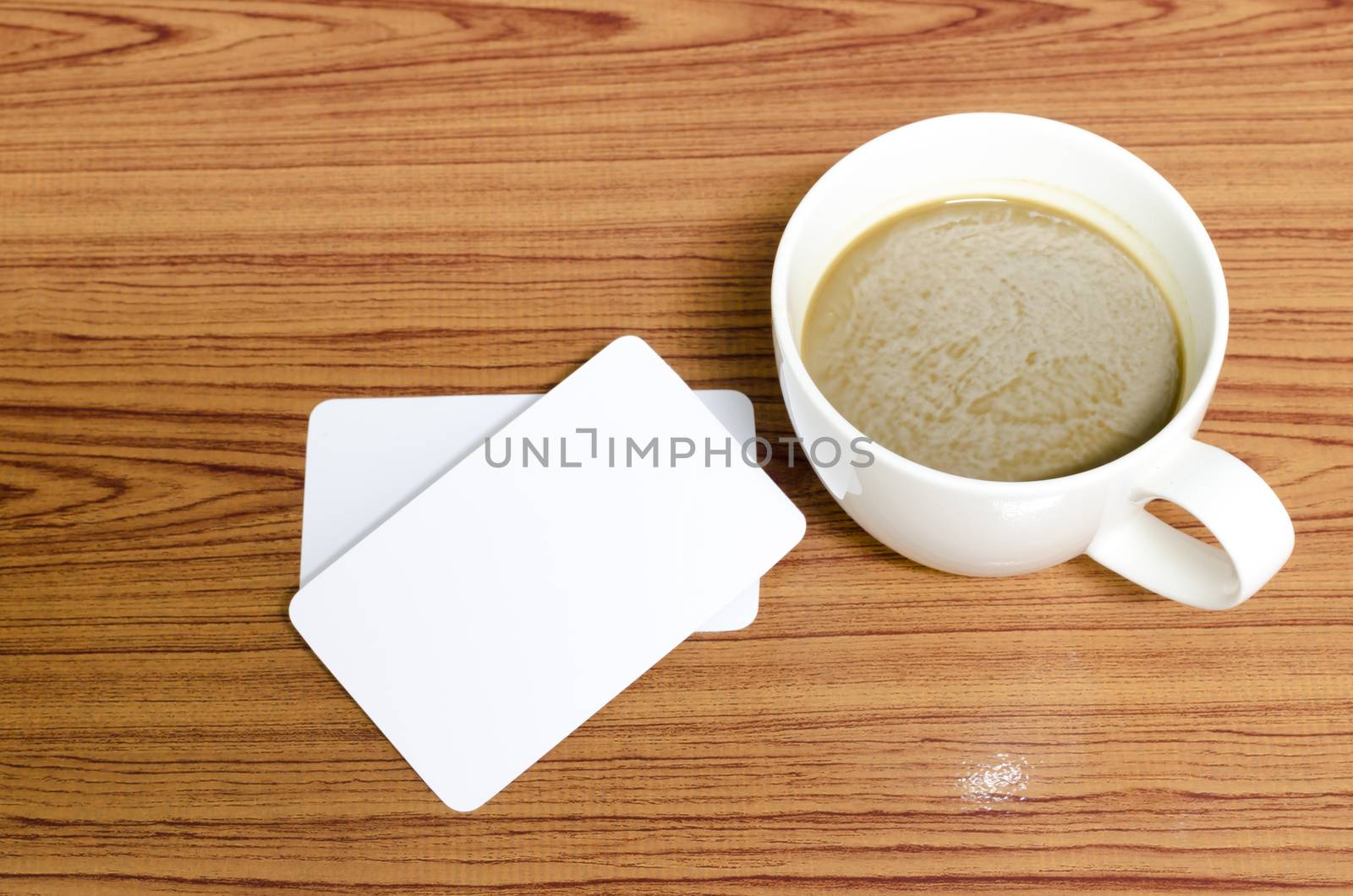 coffee cup and business card on wood background