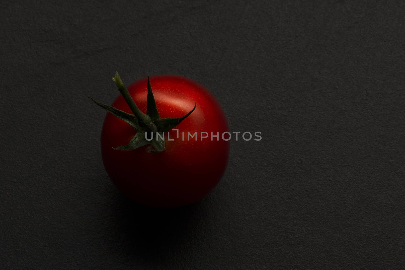 Single ripe red hothouse tomato by MOELLERTHOMSEN