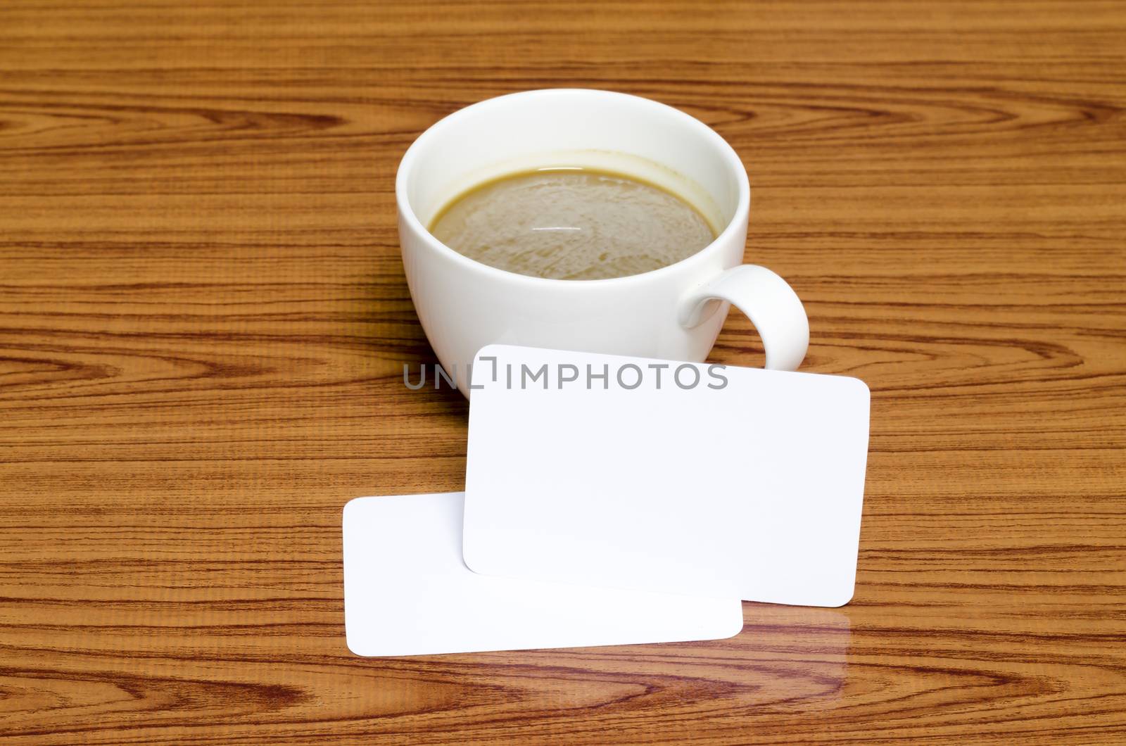 coffee cup and business card on wood background