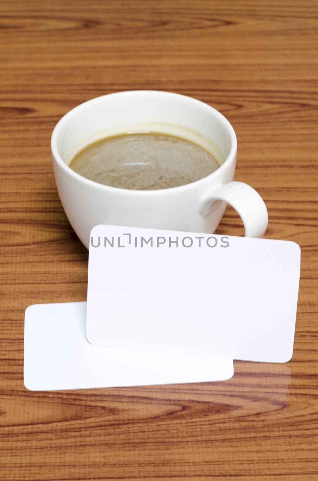 coffee cup and business card on wood background