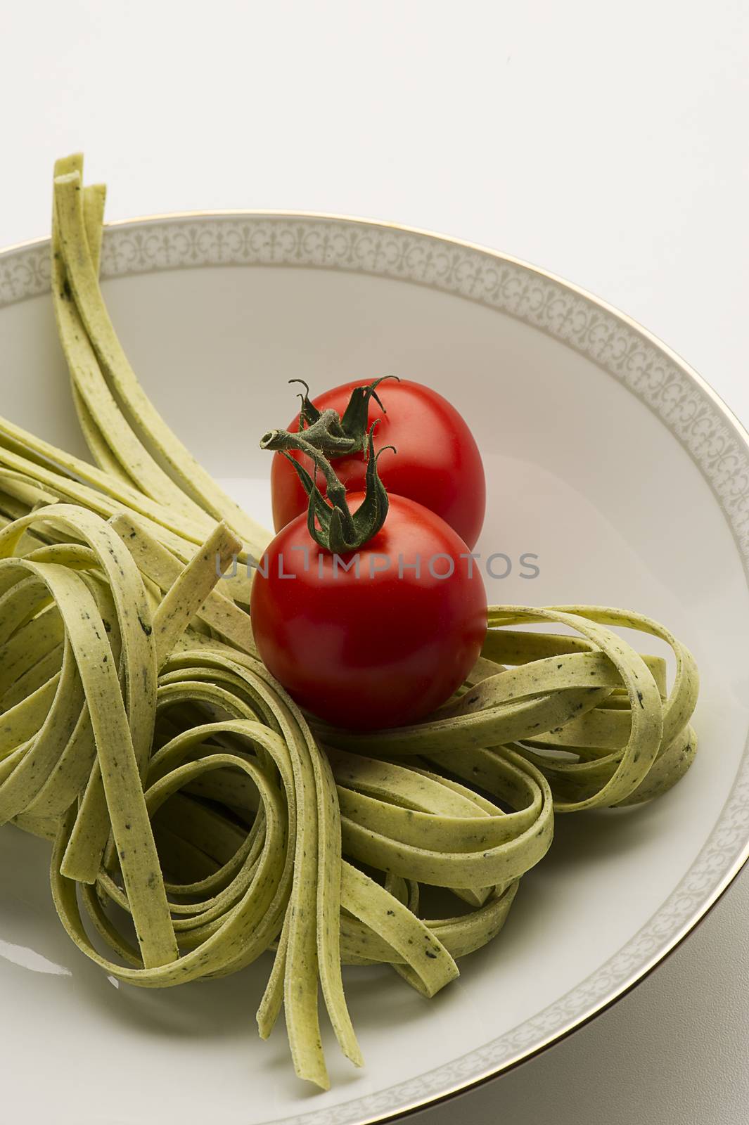 Tagliatelli pasta and fresh tomatoes by MOELLERTHOMSEN
