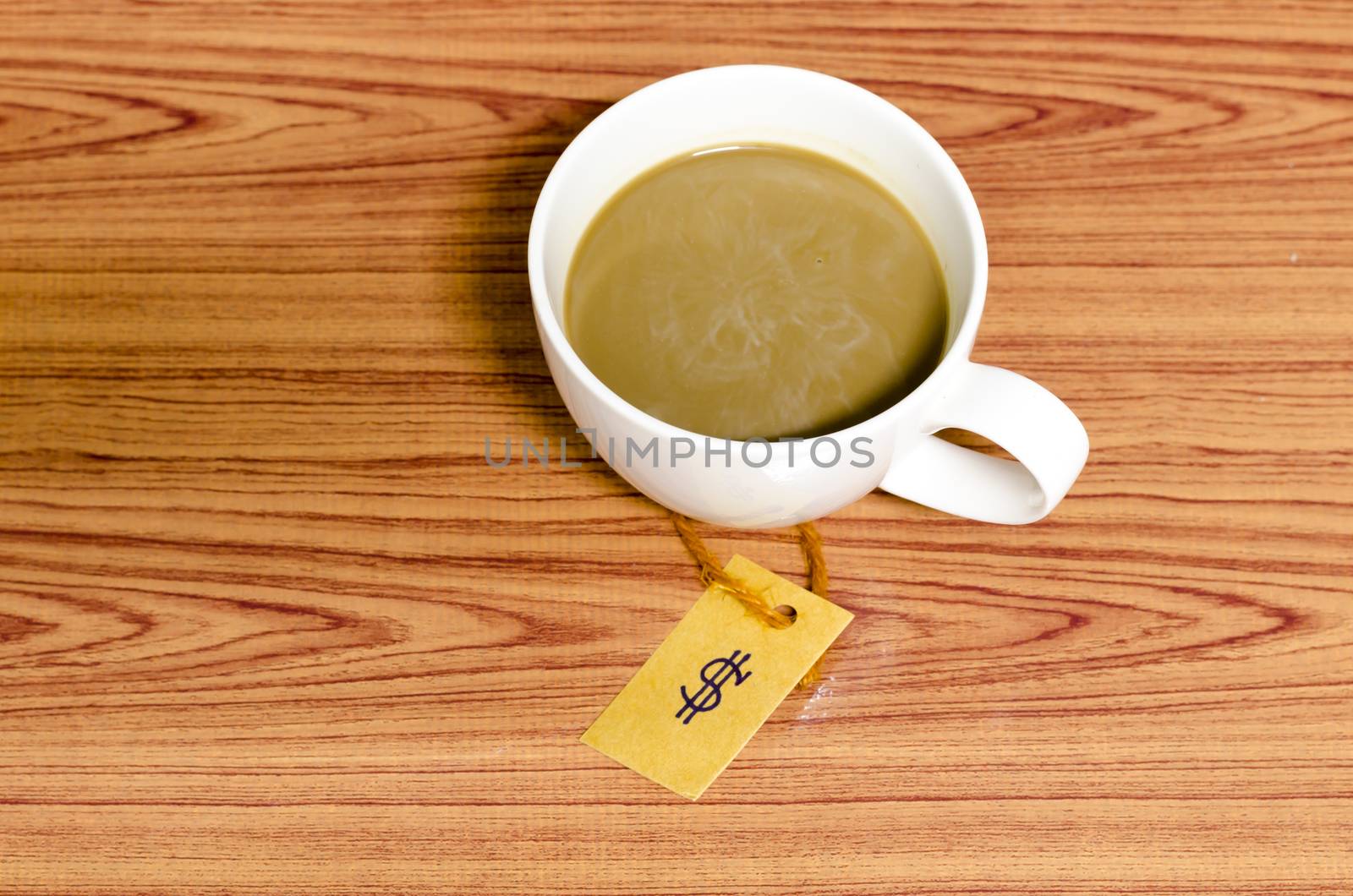 coffee cup with price tag on wood background