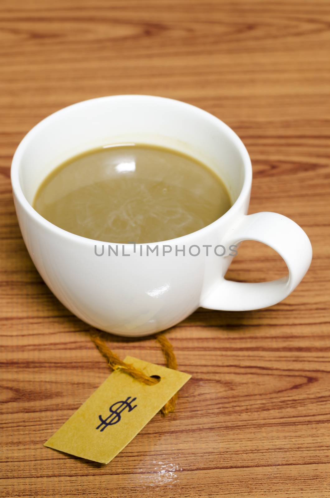 coffee cup with price tag on wood background