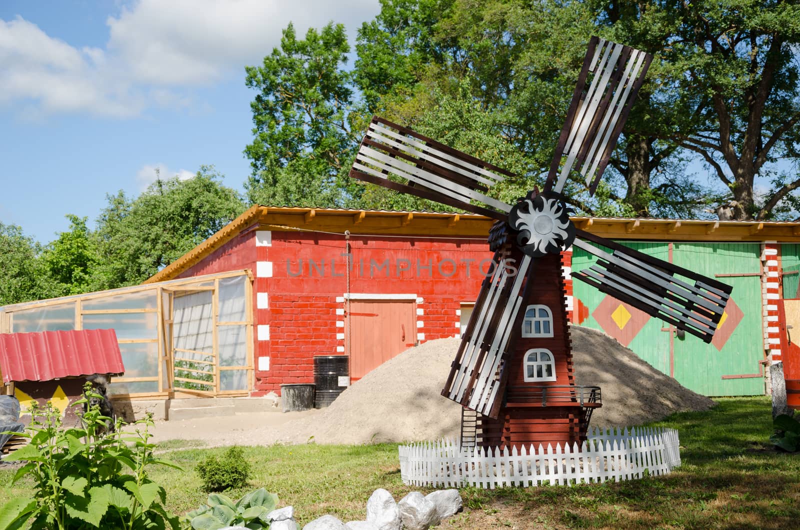 colorful country yard mill in summer time by sauletas