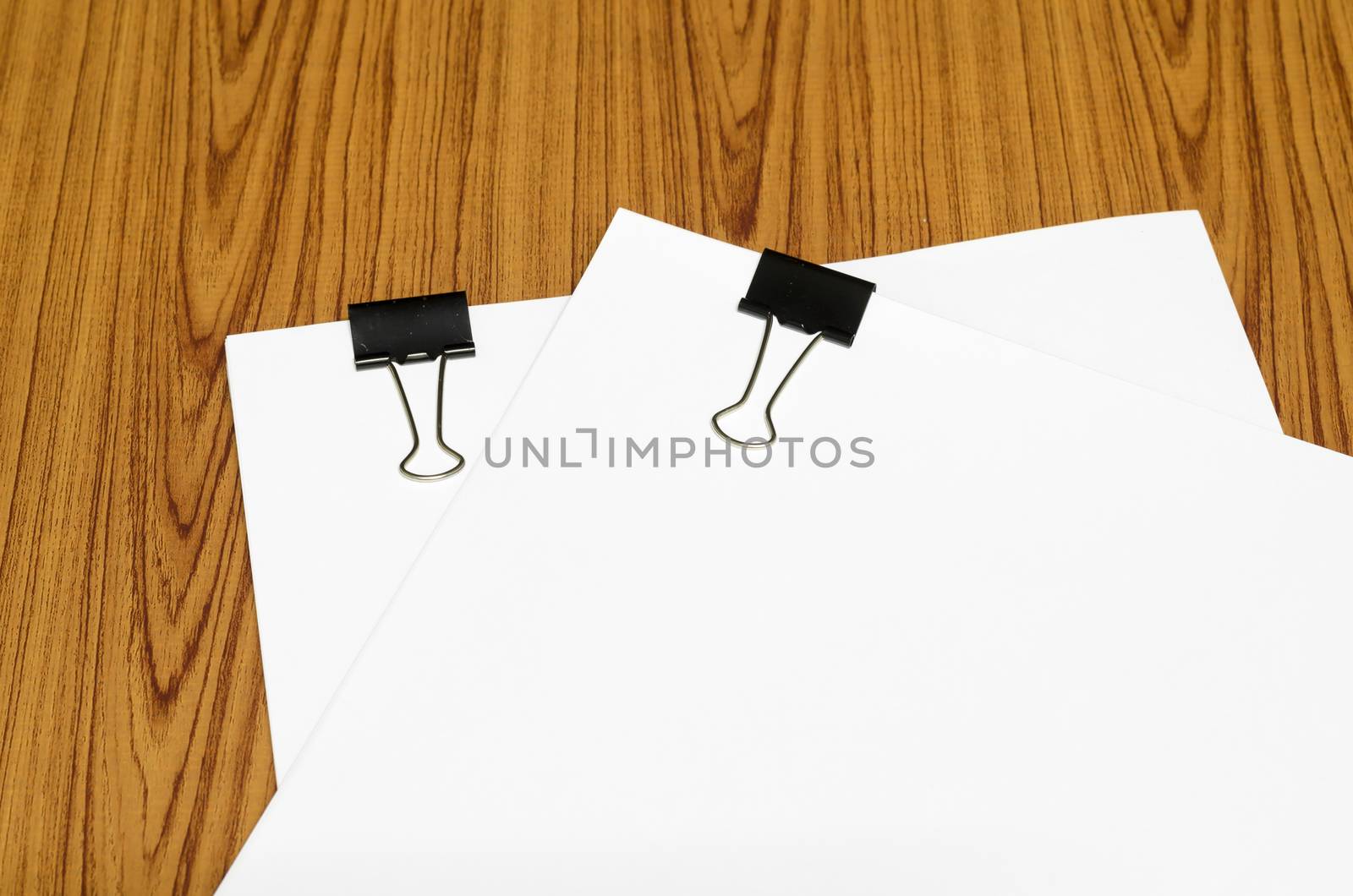 clip and paper on wood background