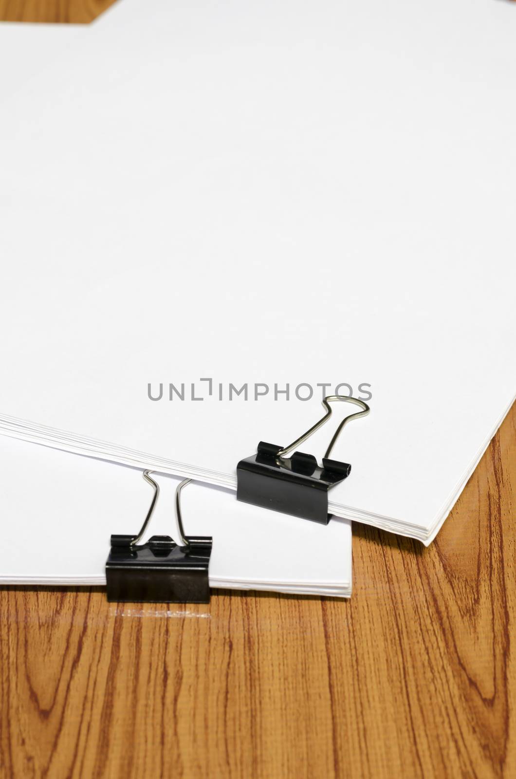 clip and paper on wood background