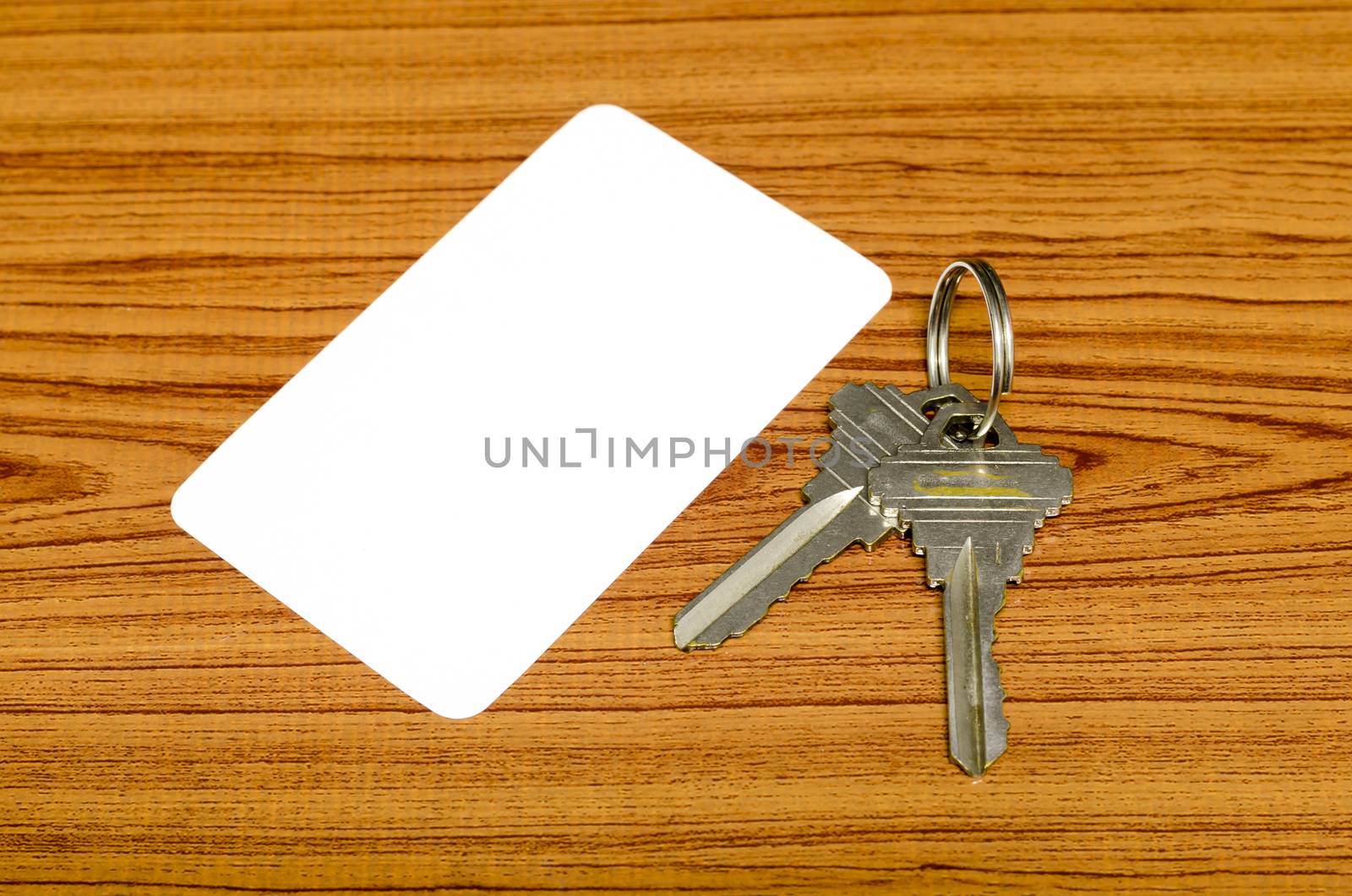 business card and keys on wood background
