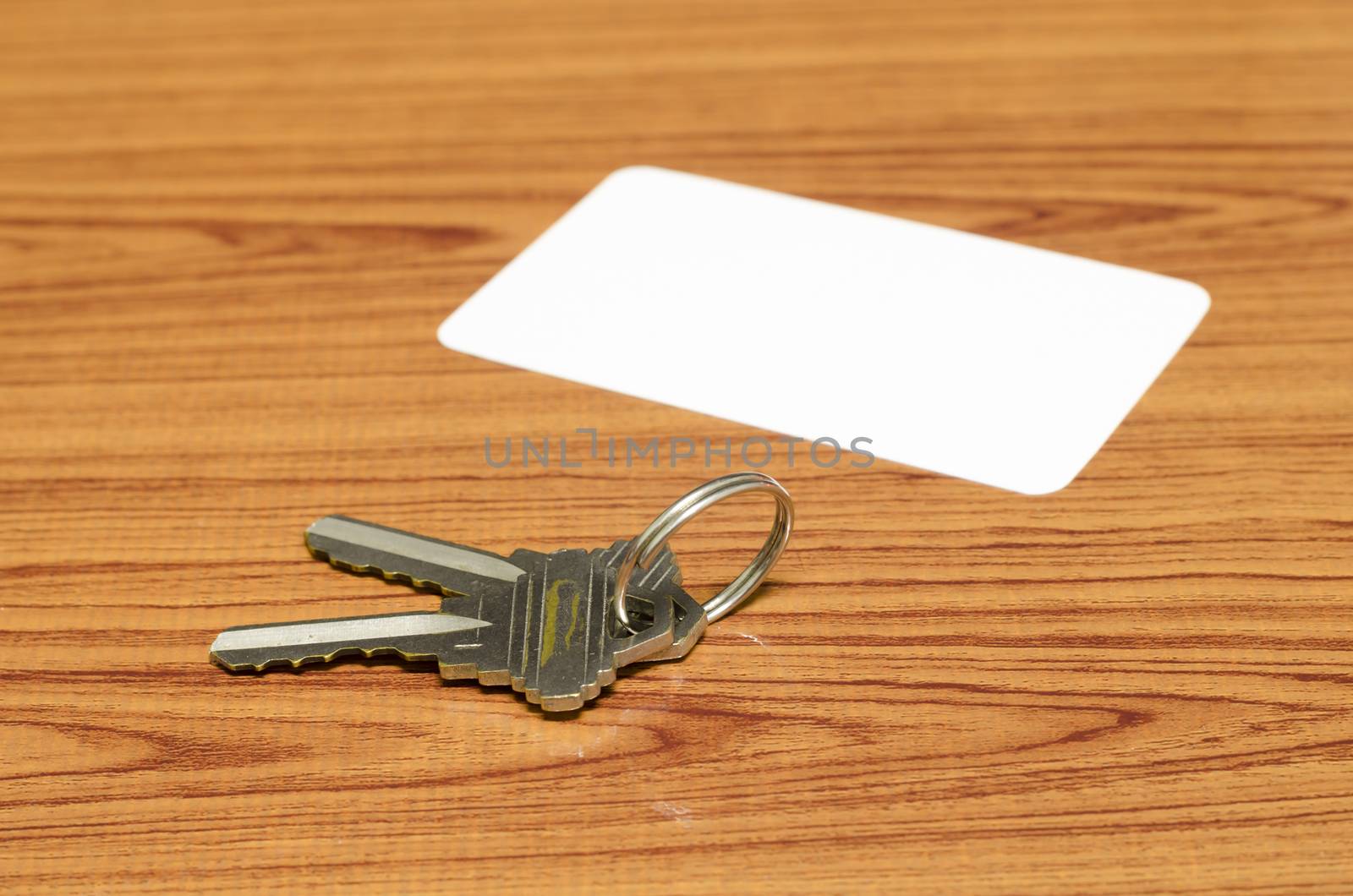 business card and keys on wood background