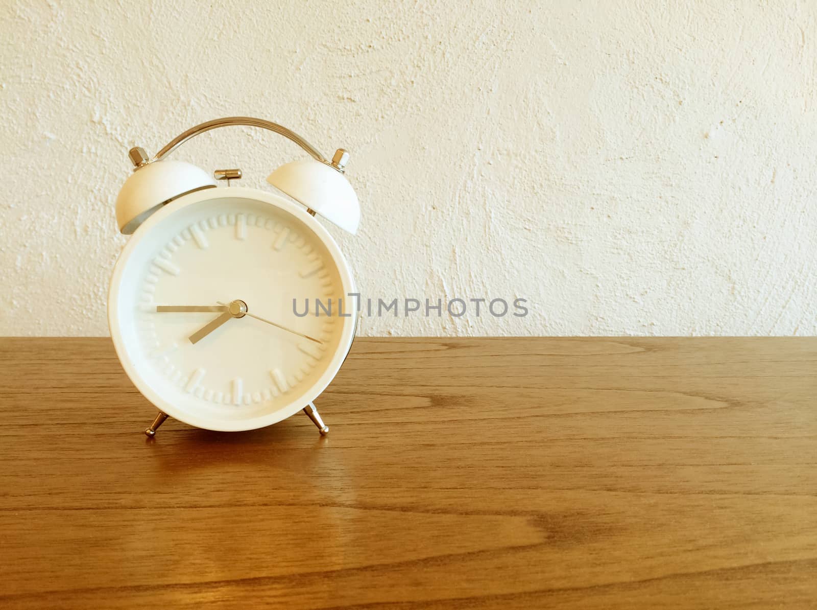 White old-fashioned alarm clock by anikasalsera