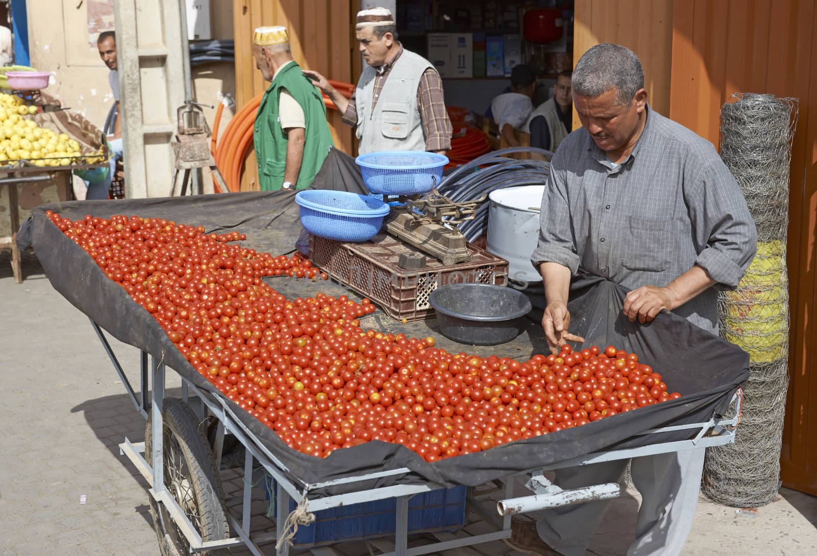 Man selling tomatoes from a hand cart in the ancient town of Taroudant in Morocco.