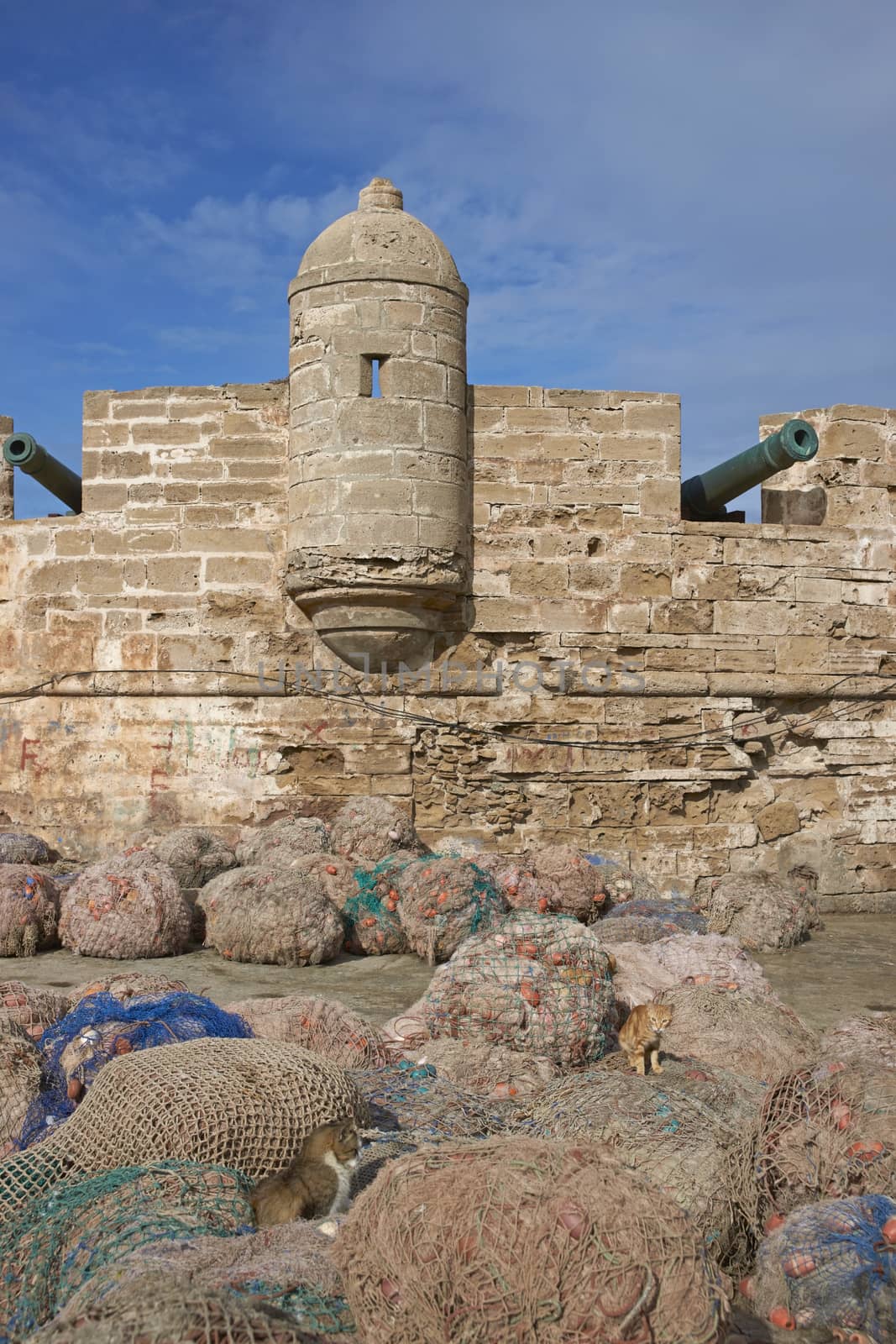 Fishing nets piled on the dockside in the historic fishing port of Essaouira in Morocco.