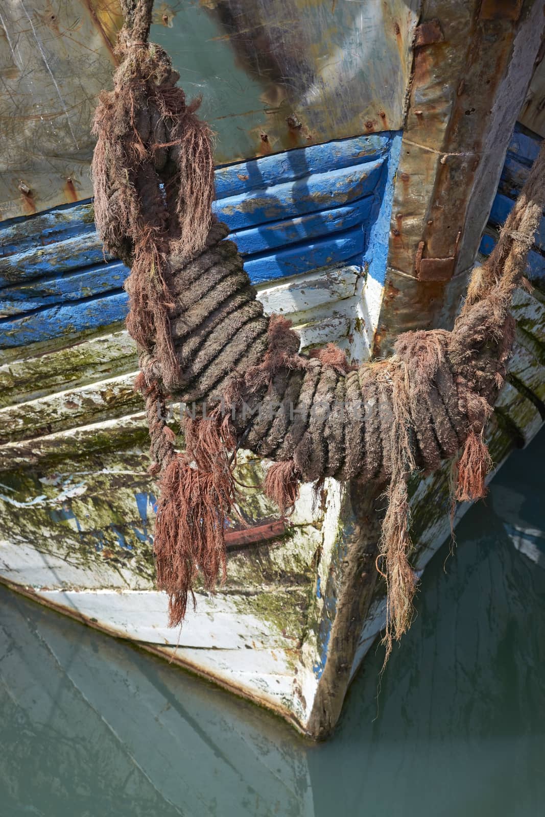 The bow of an old fishing boat in the historic harbour of Essaouira in Morocco.