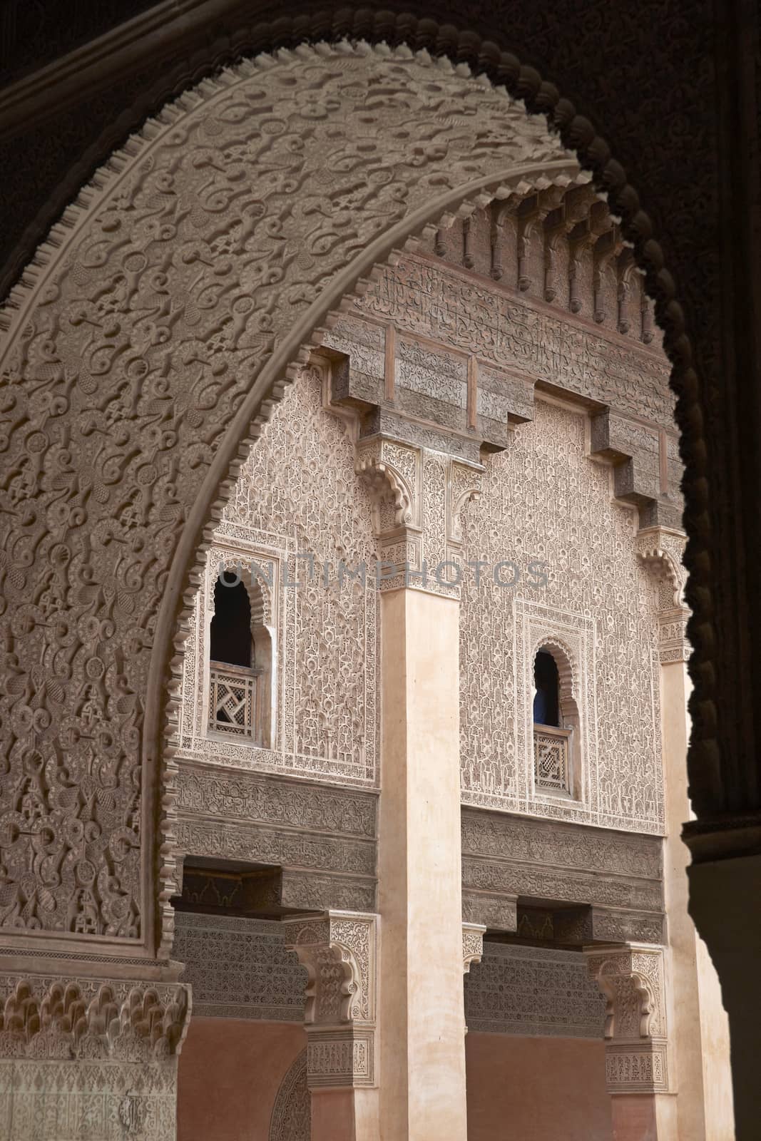 Ornate carving on the plastered walls and on the woodwork in the courtyard of the historic Ben Youssef Madrasa in the ancient heart of Marrakech in Morocco