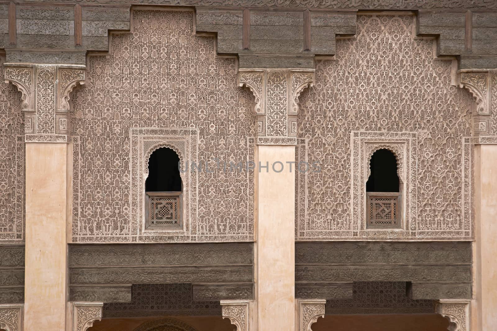 Ornate carving on the plastered walls and on the woodwork in the courtyard of the historic Ben Youssef Madrasa in the ancient heart of Marrakech in Morocco