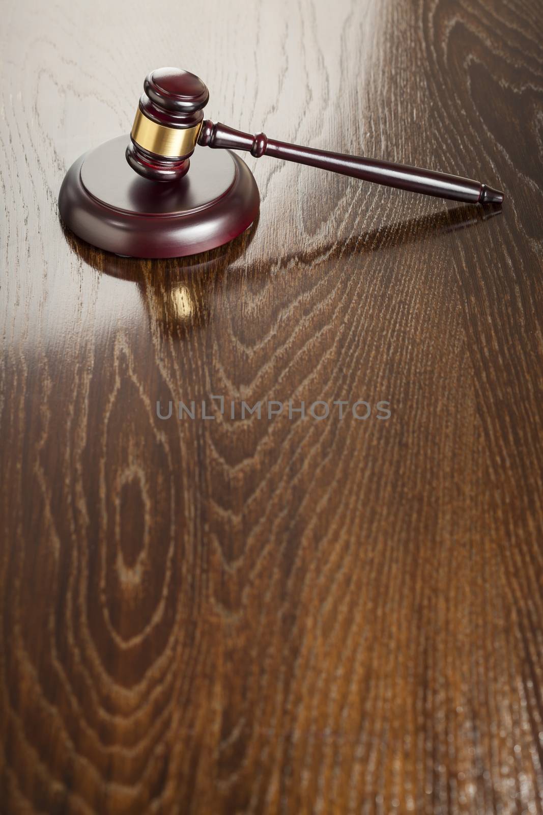 Dark Wooden Gavel Abstract on Reflective Table with Room for Text.