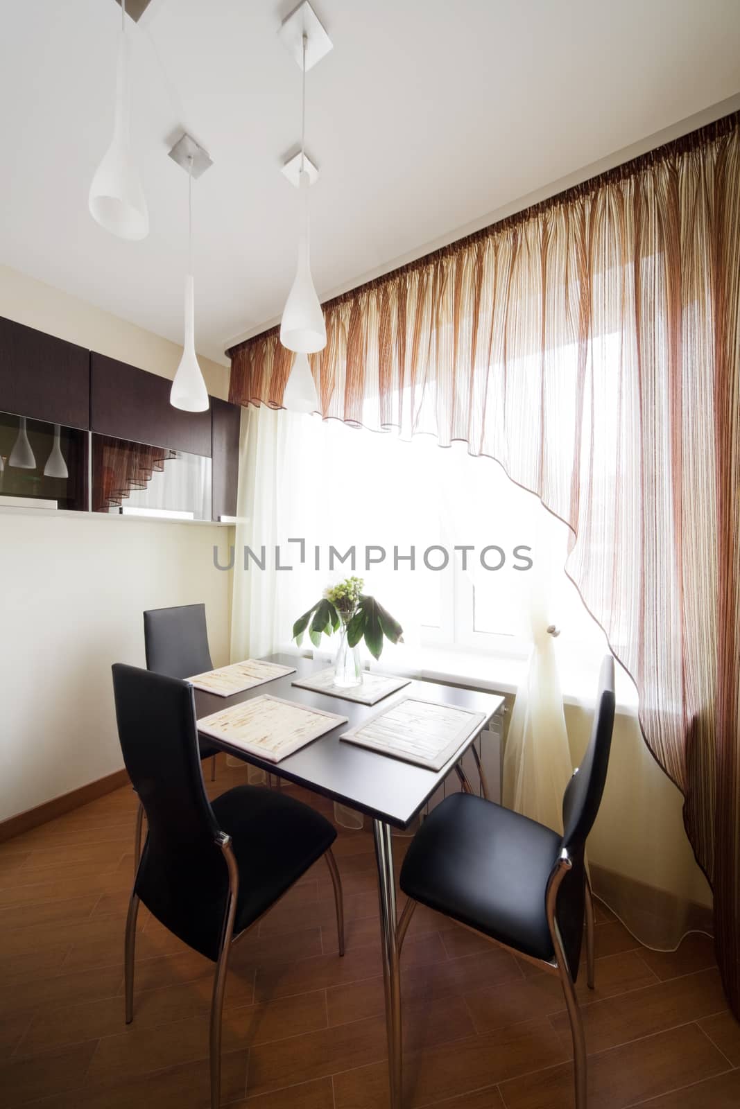 table and chairs by the window on the modern kitchen