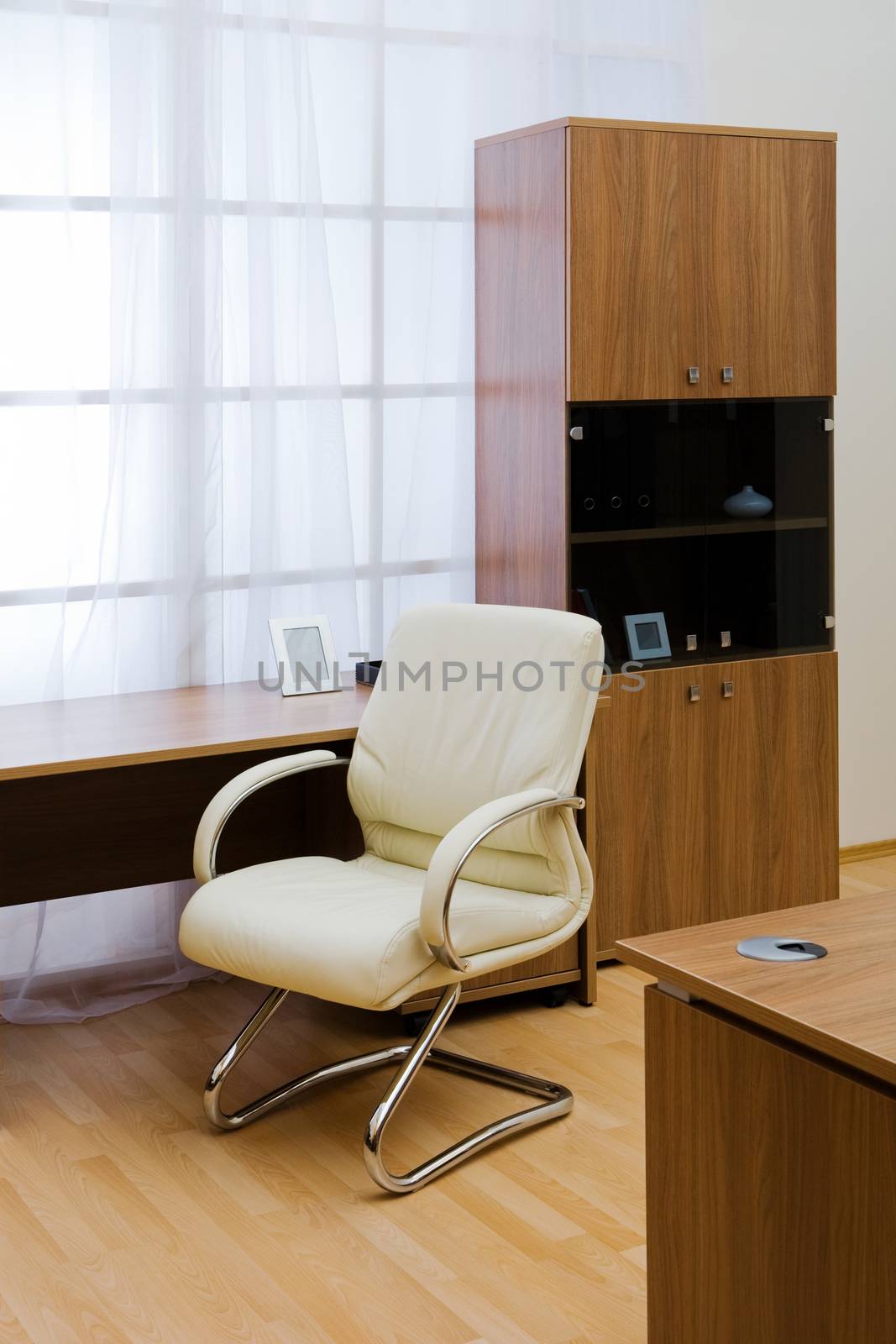 Table, chairs and bookcase at modern office