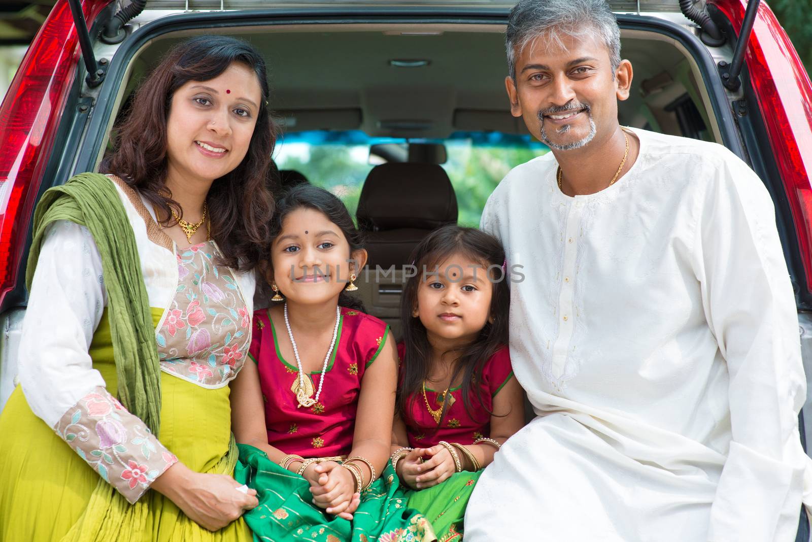Indian family sitting in car. by szefei