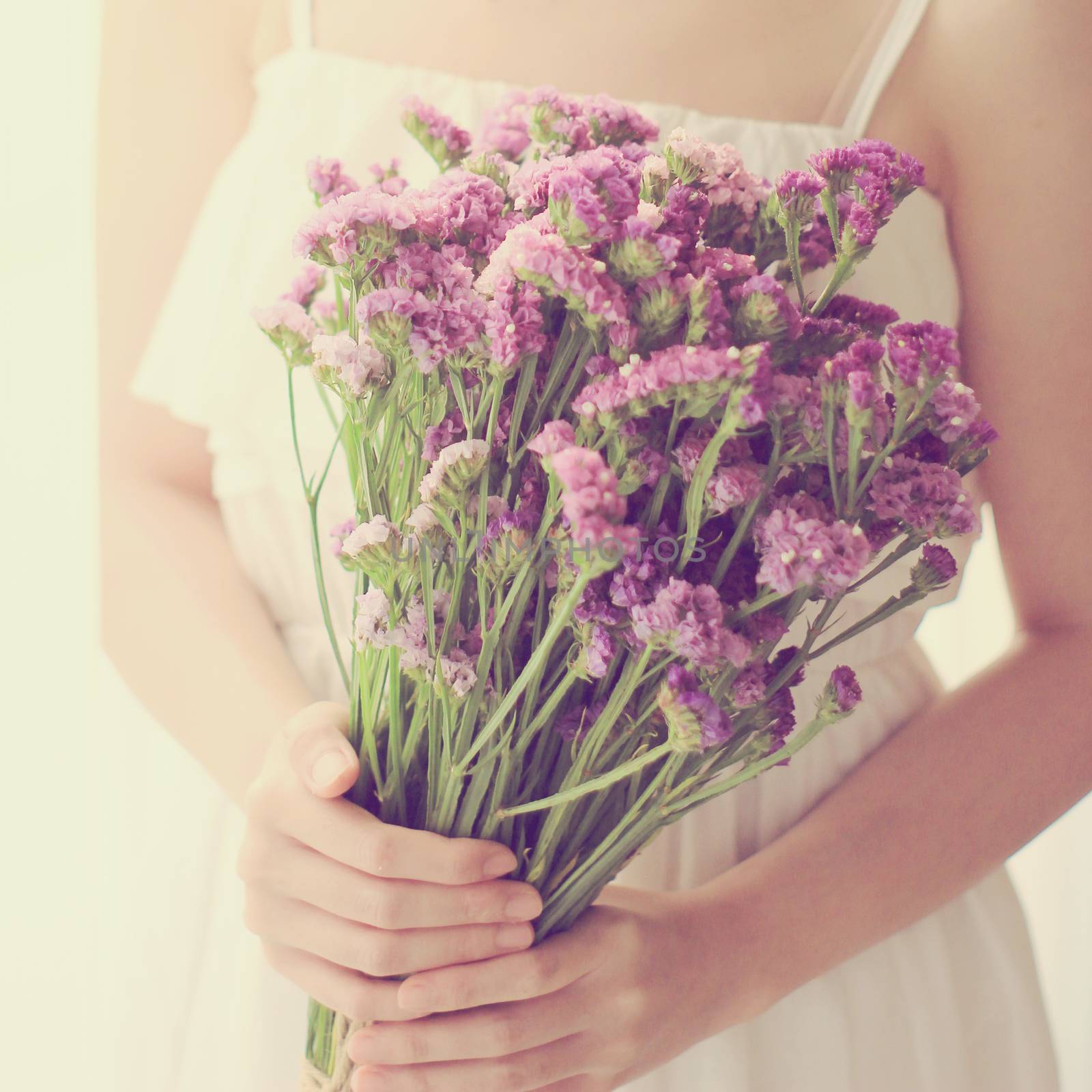 Bride or bridemaid with bouquet, closeup with retro filter effec by nuchylee